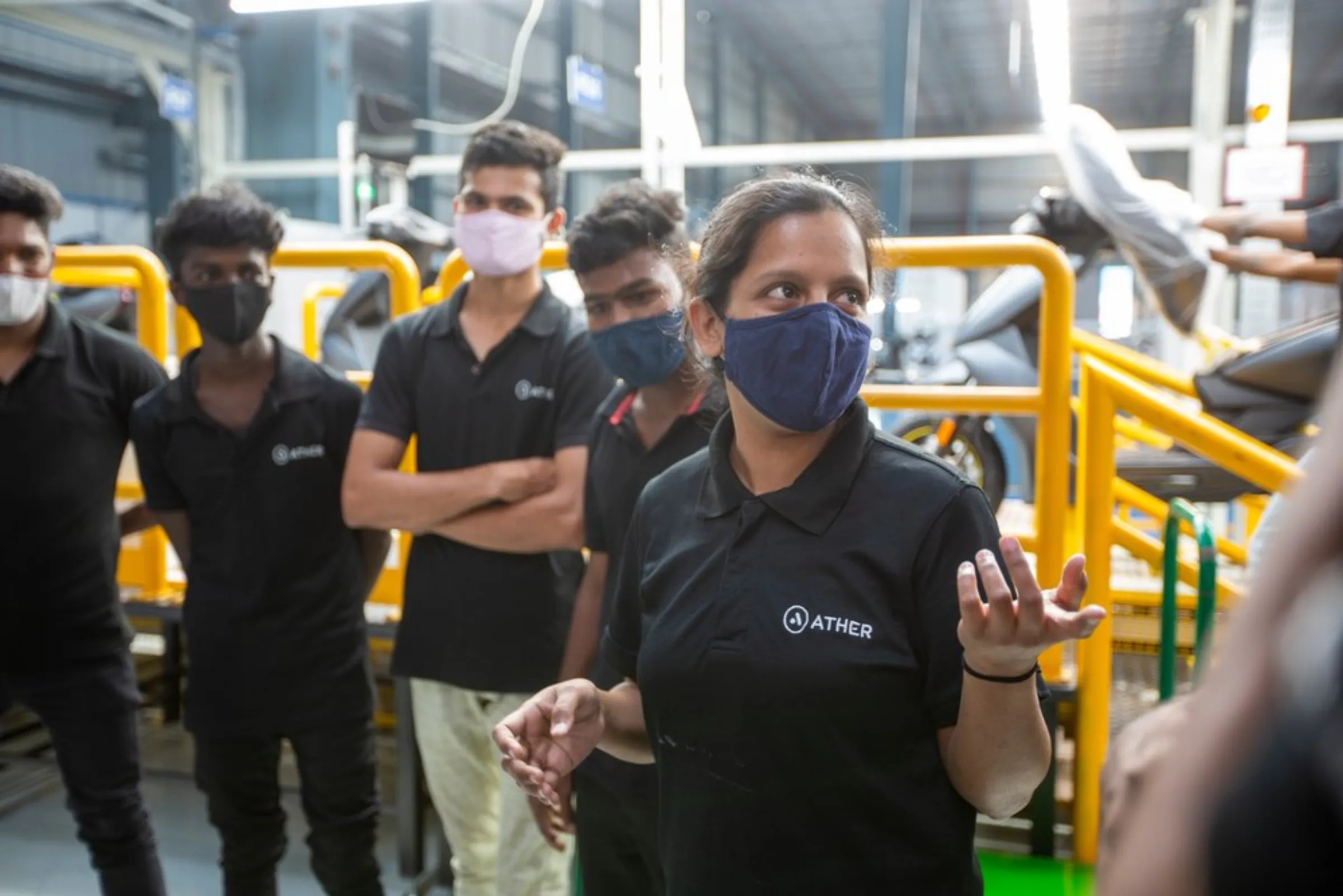 Nasreen Banu with her co-workers at the Ather Energy factory in Hosur, India, April 20, 2022