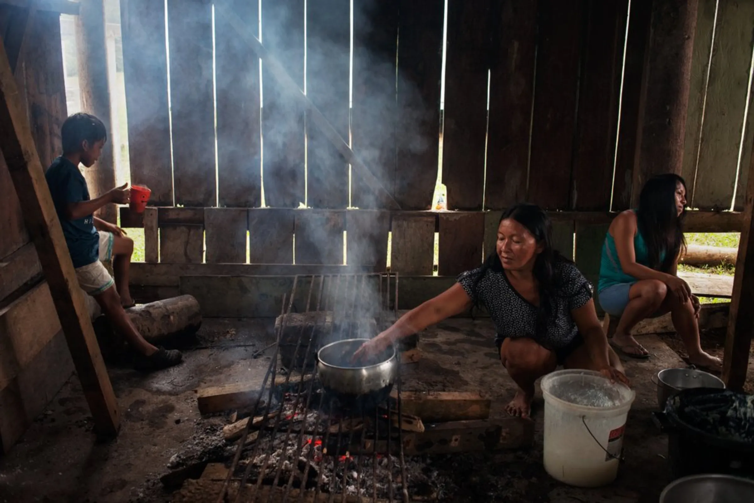 Women from the Waorani indigenous group prepare a fish stew at a rainforest village in the province of Pastaza, Ecuador, on April 26, 2022