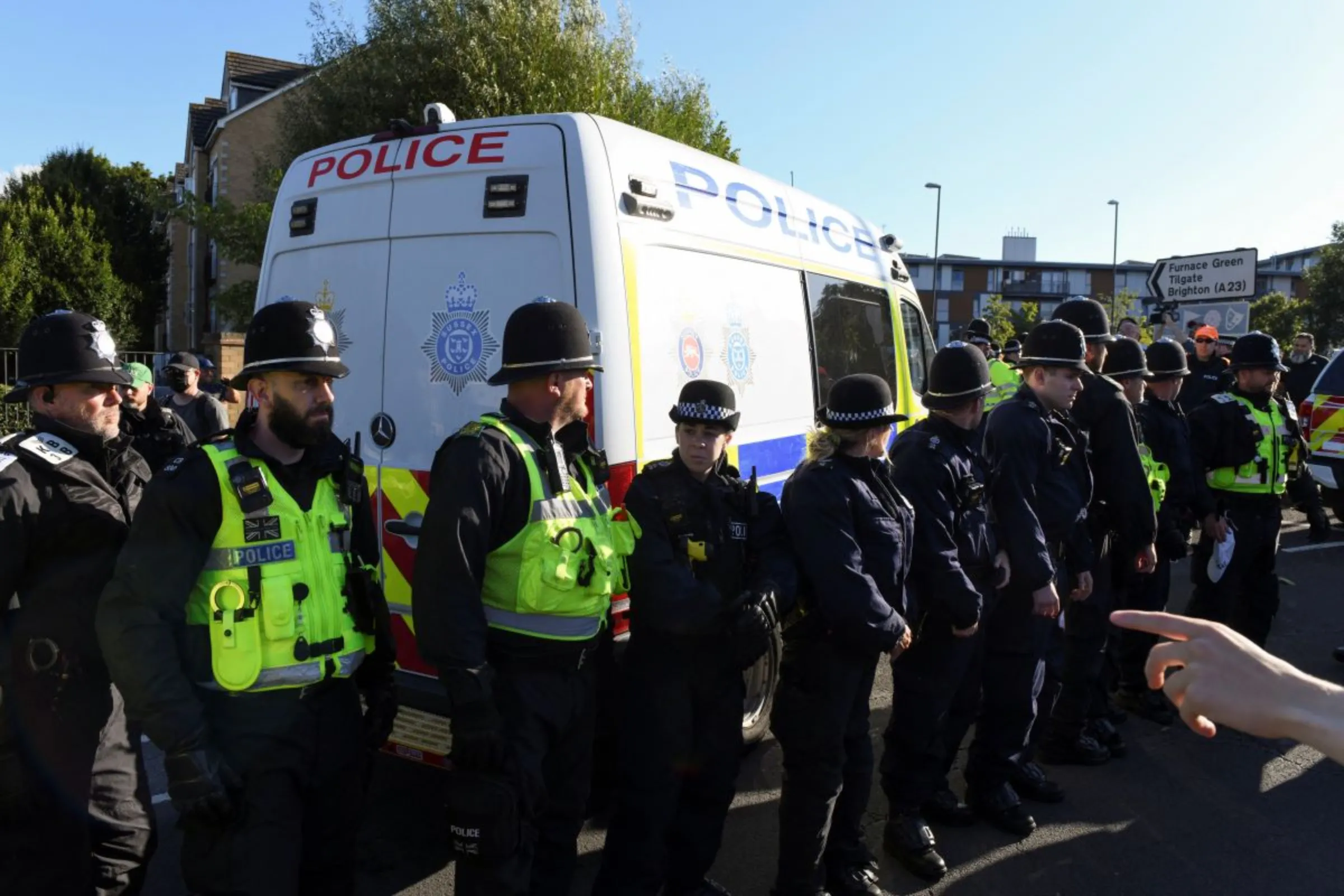 Police officers stand guard as an anti-racism protest takes place at a Holiday Inn Express hotel in Crawley, Britain, August 9, 2024. REUTERS/Chris J. Ratcliffe