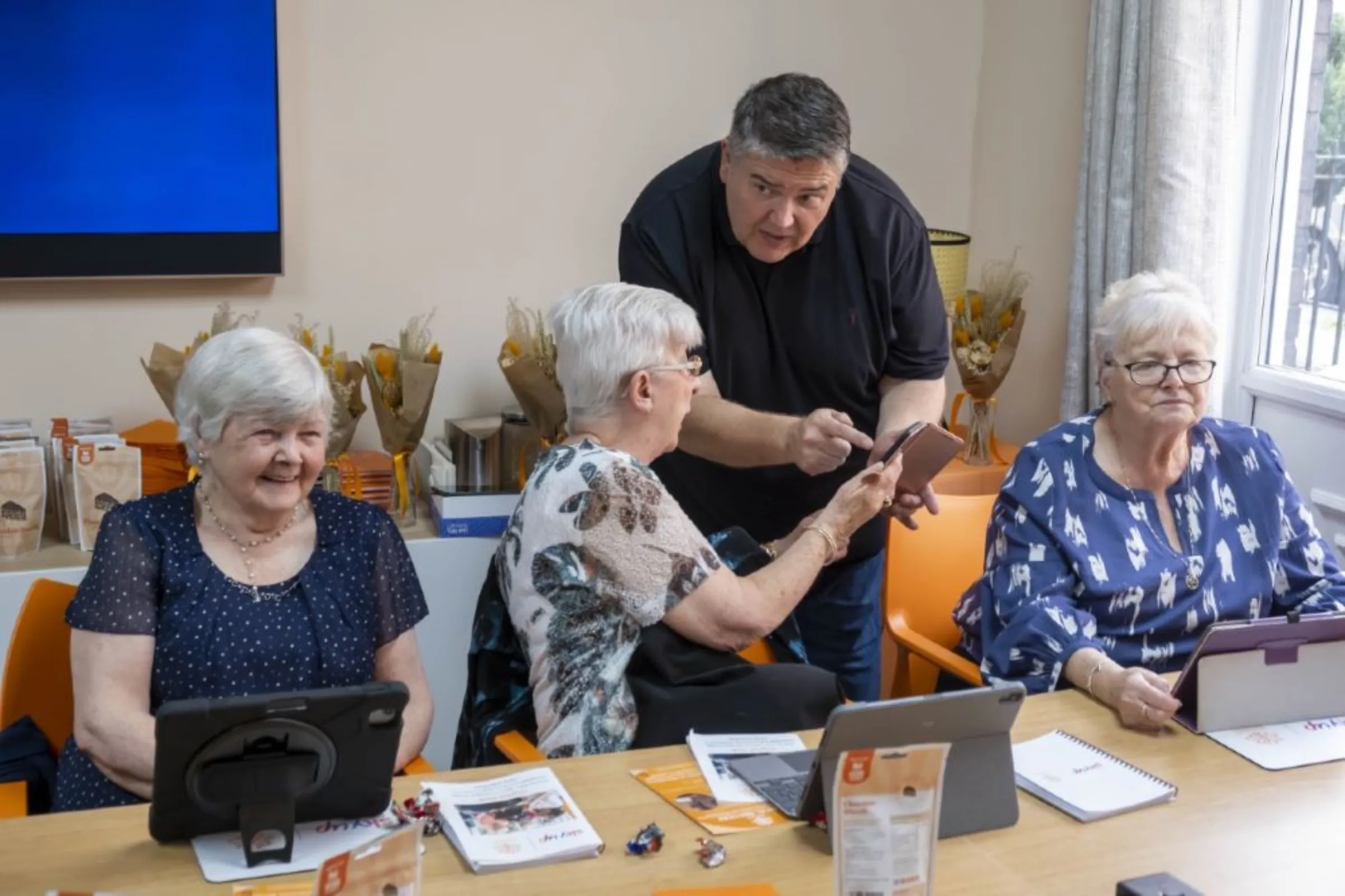Older people in Glasgow learn how to use tablet computers and the internet