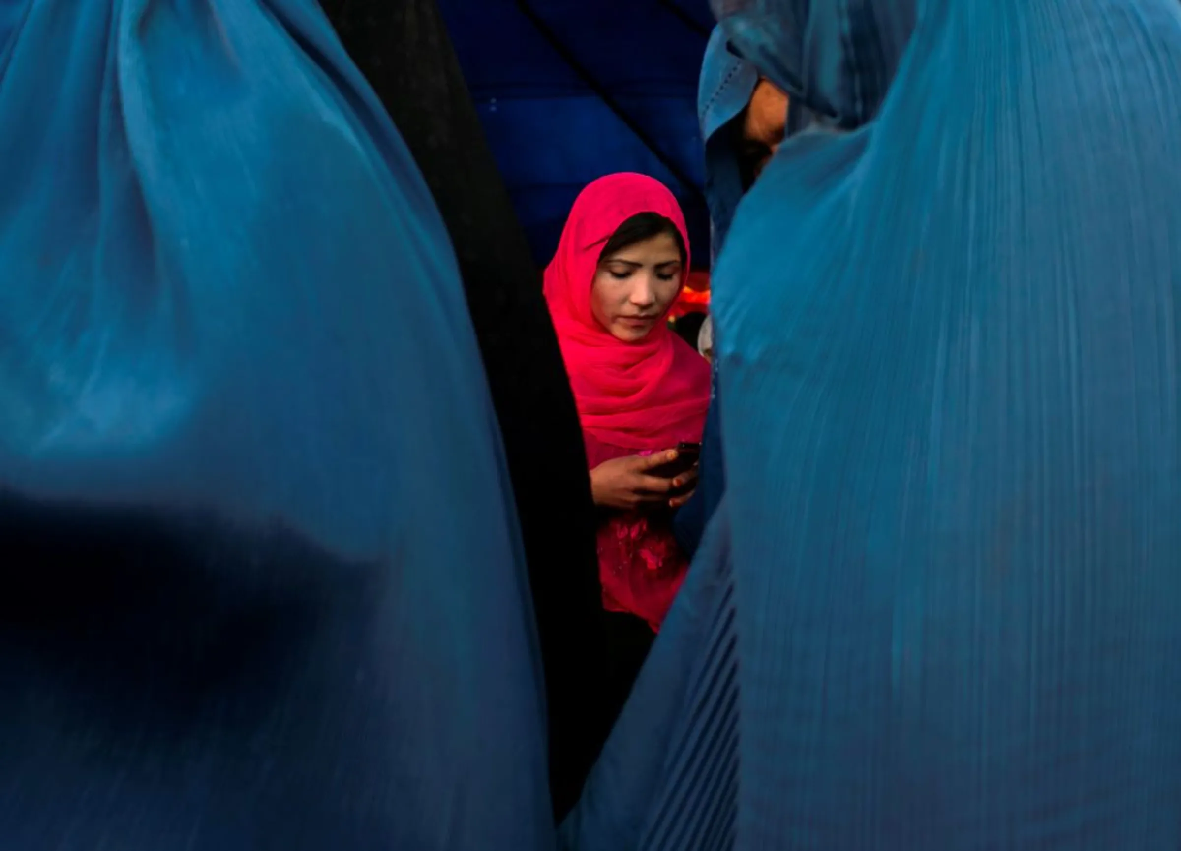 An Afghan woman holds her phone after an election campaign by Afghan presidential candidate Ashraf Ghani Ahmadzai in Kabul June 8, 2014