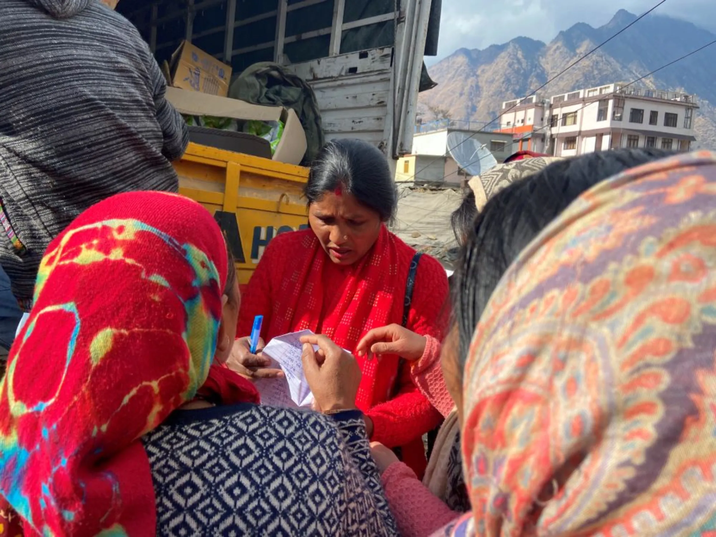 Women jostle to register their names for free ration supplies in the Himalayan town of Joshimath, India, January 13, 2023