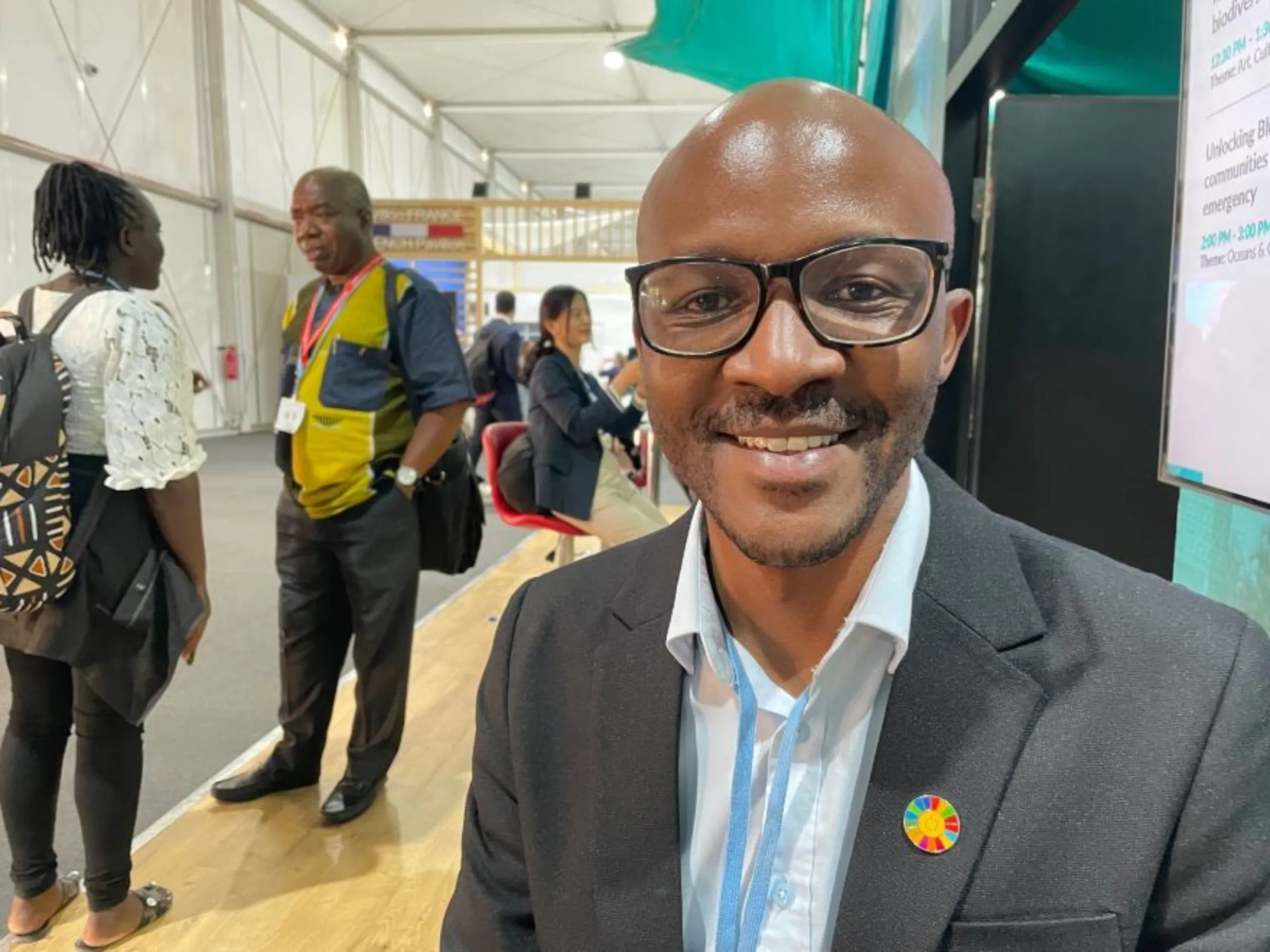 Innocent Tshilombo, an entrepreneur in Kenya's Kakuma refugee camp and himself a refugee from the Democratic Republic of Congo, poses for a photo at the COP27 U.N. climate talks in Sharm El-Sheikh, Egypt, November 16, 2022