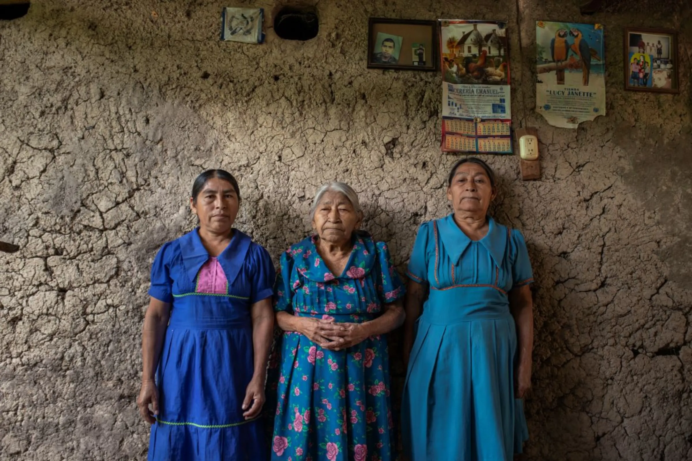 Monica Ramirez de Leon, left, with her grandmother and mother in her adobe home in a hamlet in the Camotán municipality in the province of Chiquimula, Guatemala, September 8, 2023. Thomson Reuters Foundation/Fabio Cuttica