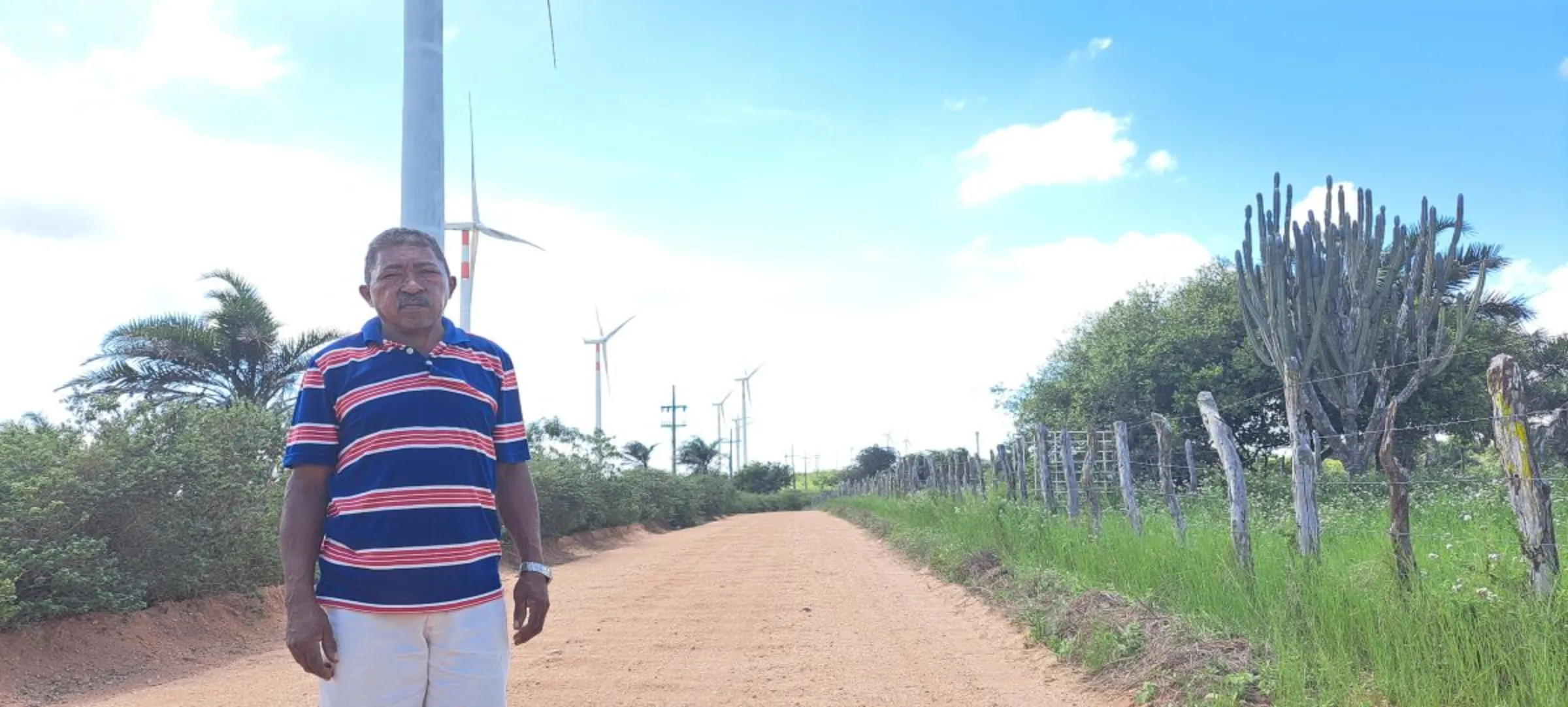 Antonio Domingos da Silva, an indigenous leader from Baixa do Lero, a Pankararu village, poses for a picture besides wind towers near his land in Pernambuco, Brazil, May 12, 2023. Fabio Teixeira/Thomson Reuters Foundation