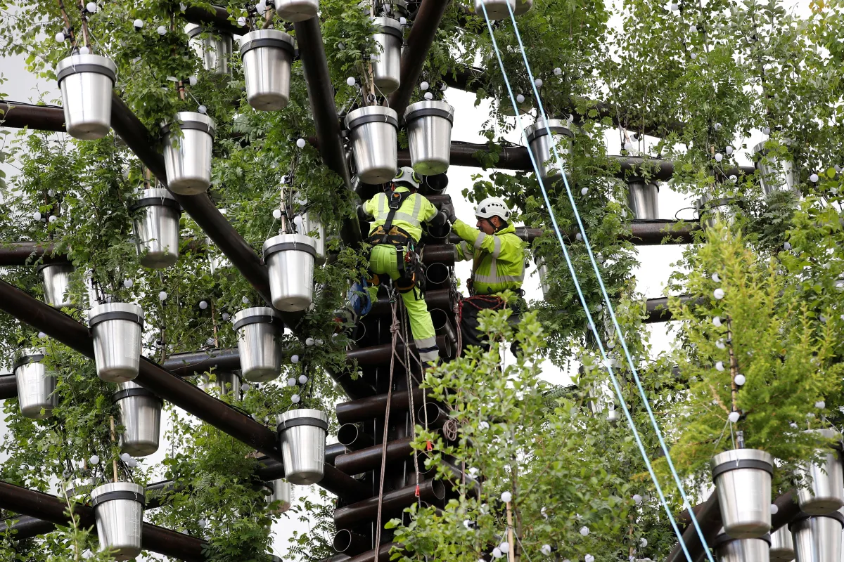 A team of workers add the final parts to the Queen's Green Canopy ahead of the Platinum Jubilee in London, Britain, May 24, 2022. REUTERS/Peter Nicholls/Pool