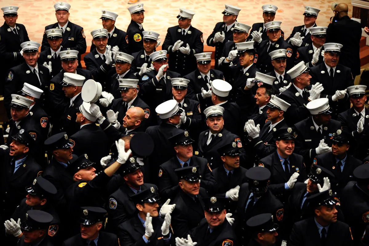 Members of the New York City Fire Department (FDNY) take part in a Fire Officers Promotion Ceremony, following the announcement all city employees to show proof of inoculation against the coronavirus disease (COVID-19) or be placed on unpaid leave, in New York City, U.S., October 20, 2021. REUTERS/Lloyd Mitchell