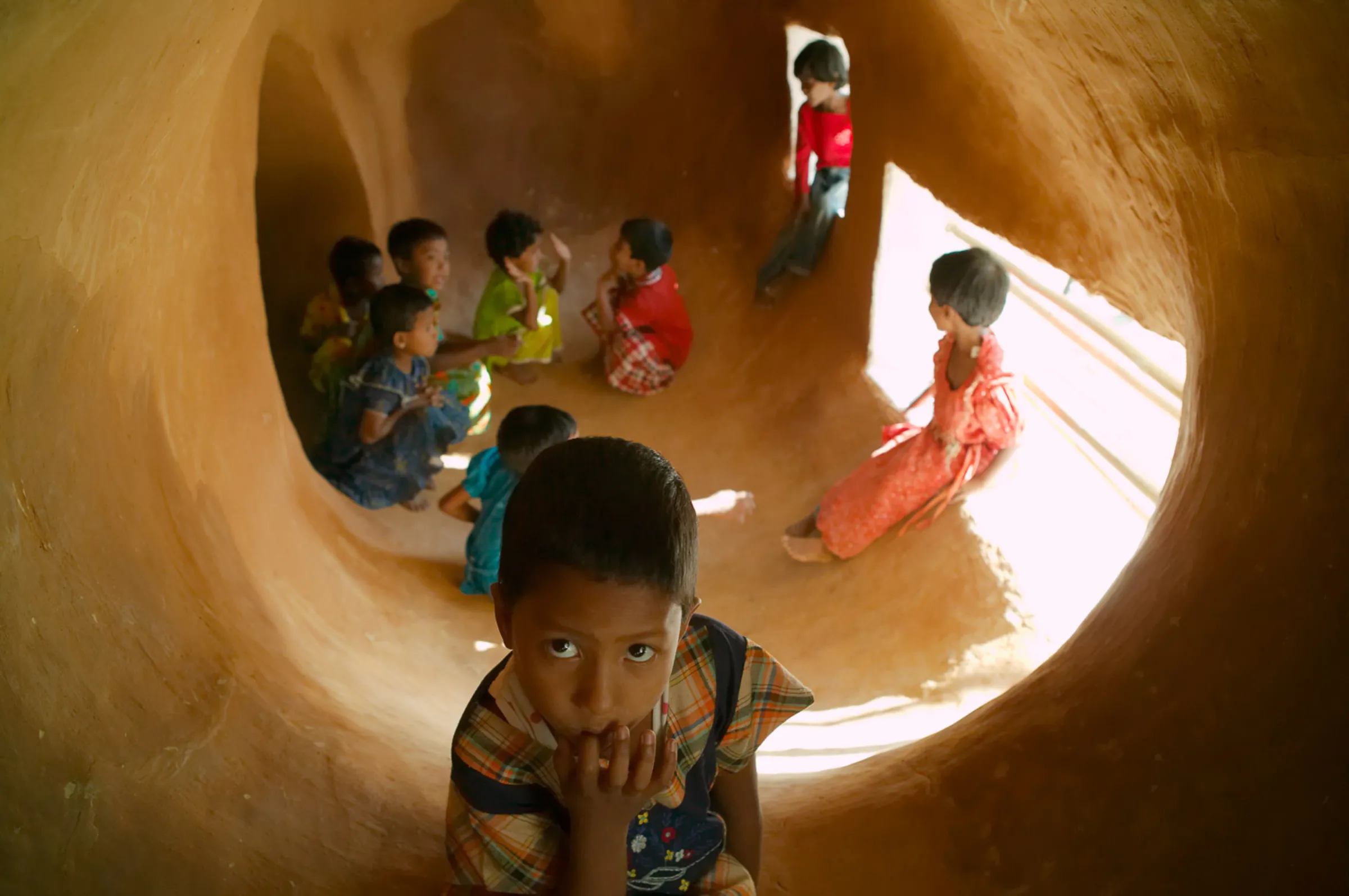 Children play in an earthen cave built inside the METI school in Bangladesh. Kurt Hoerbst/Handout via Thomson Reuters Foundation