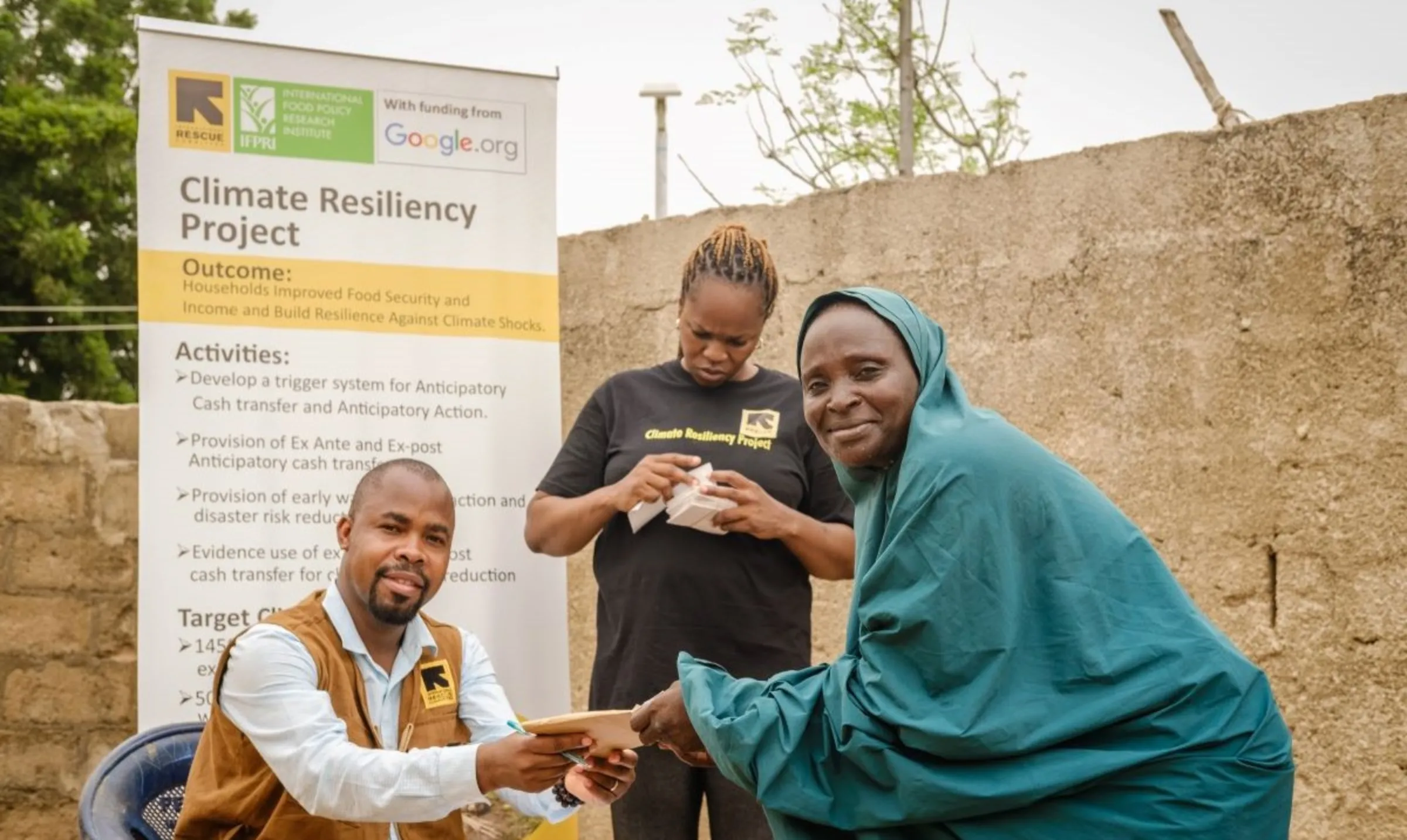 Fish farmer, Faiza Habibu, receives funds from International Rescue Committee in Dasin Hausa, Adamawa, Nigeria on October 4, 2023. International Rescue Committee (IRC)/Handout via Thomson Reuters Foundation