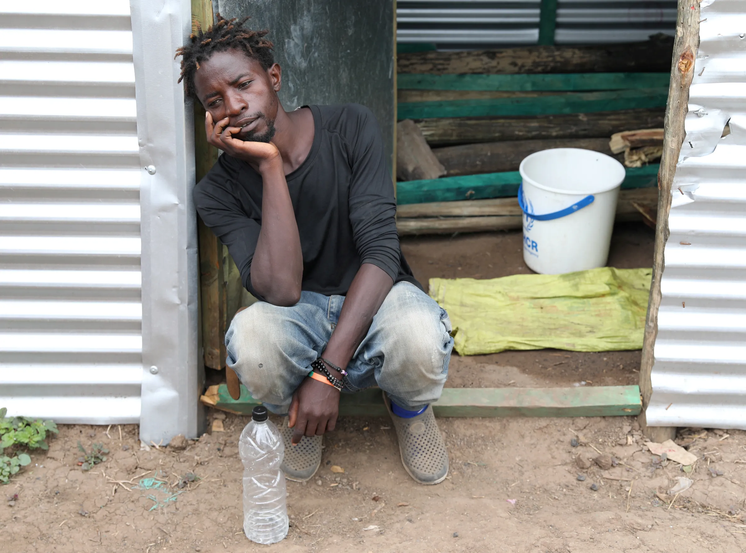 A refugee  sits by the door of a shelter at the Kakuma refugee camp, in Turkana county, northwest of Nairobi, Kenya February 22, 2020. REUTERS/Goran Tomasevic