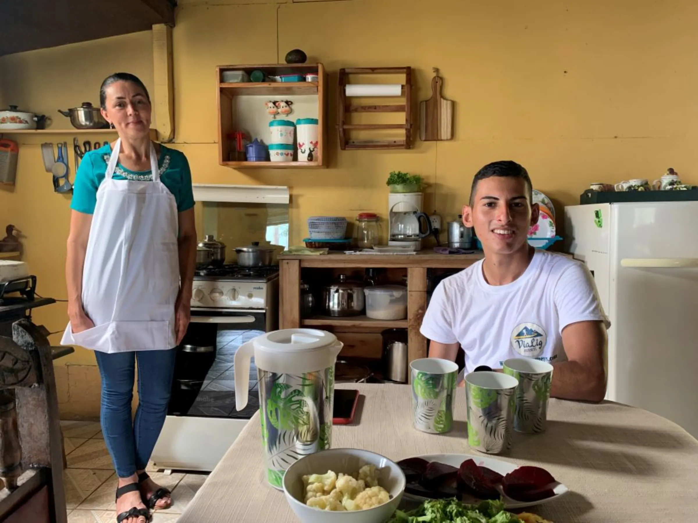 Greylin Fallas Cordero (left) prepares lunch for guide Alejandro Montoya (right) at her home in Napoles, Costa Rica, November 13, 2022. Napoles lies on the 174-mile Camino de Costa Rica footpath, that starts in Barra de Pacuare and finishes in Quepos, on the Pacific