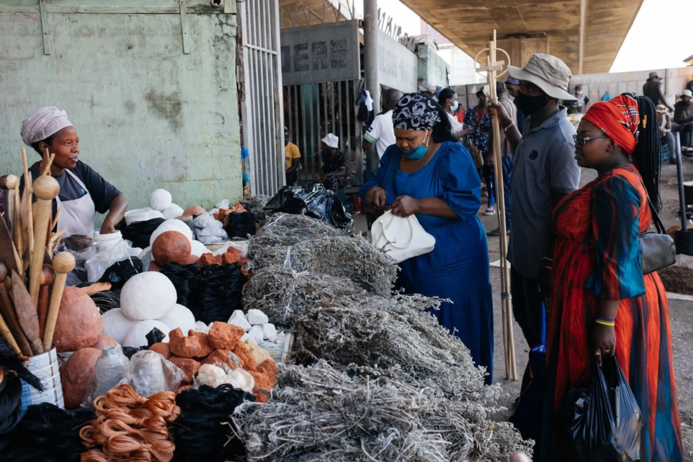 Potential buyers look at the wares at Warwick Market in inner-city Durban, March 31, 2021. Informal traders at the busy market offer everything from fresh produce and traditional medicine to clothes and music