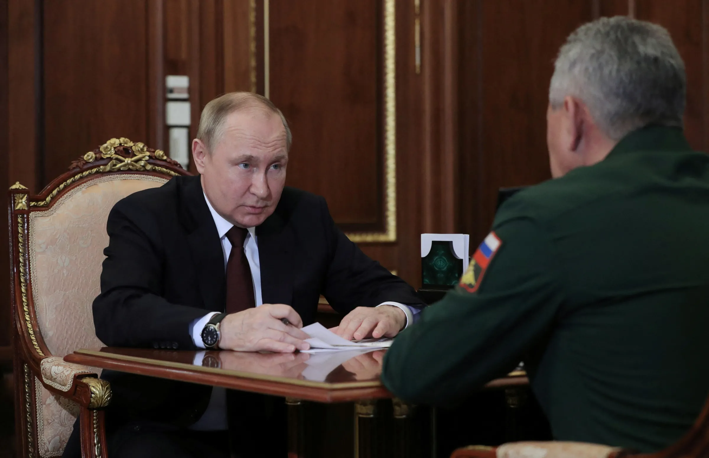 Russian President Vladimir Putin attends a meeting with Defence Minister Sergei Shoigu in Moscow