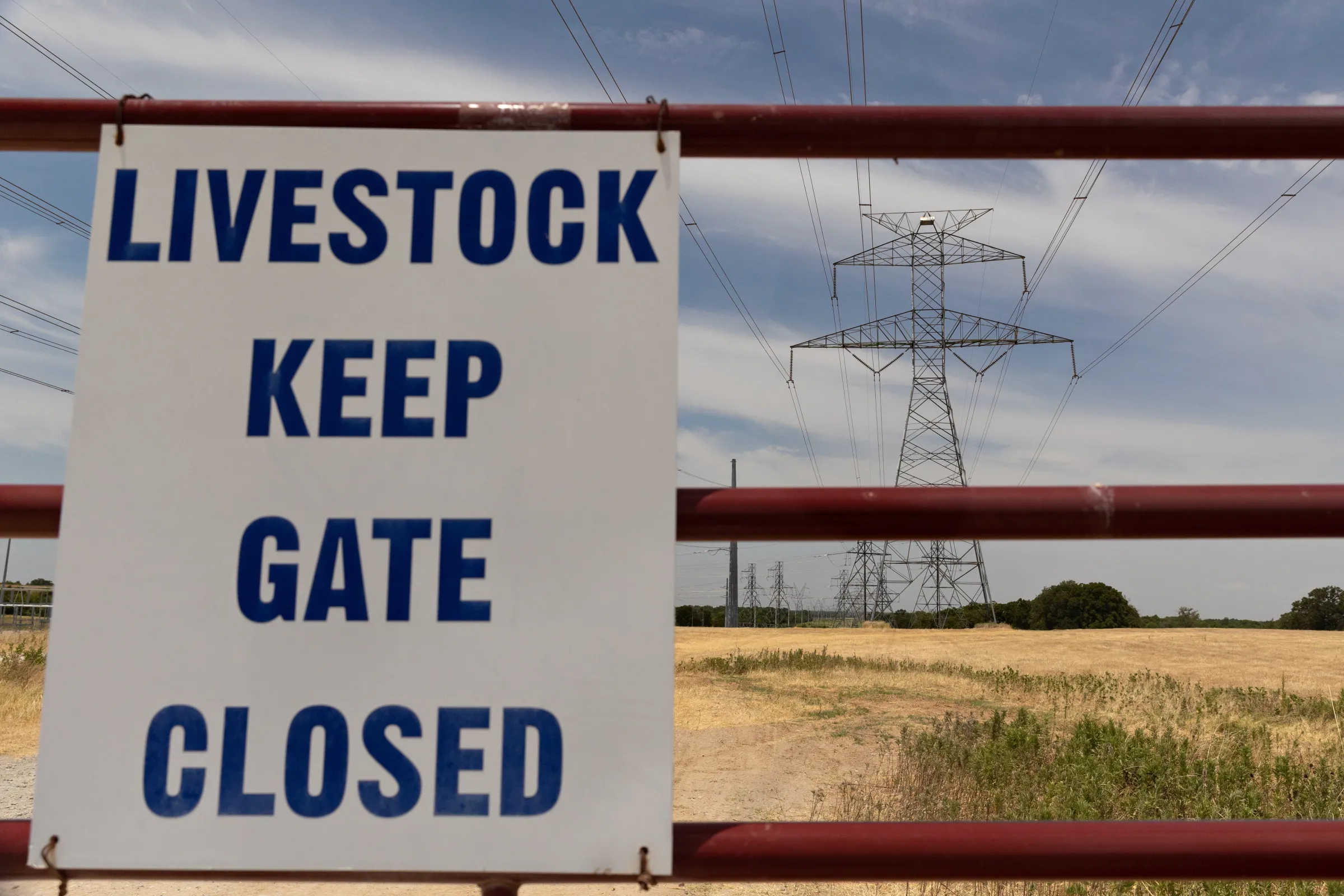 A sign on a gate is pictured in front of an electrical substation in Navarro County, which a future Bitcoin mine will be built next-door to in Texas, United States, July 21, 2022. Thomson Reuters Foundation/Shelby Tauber