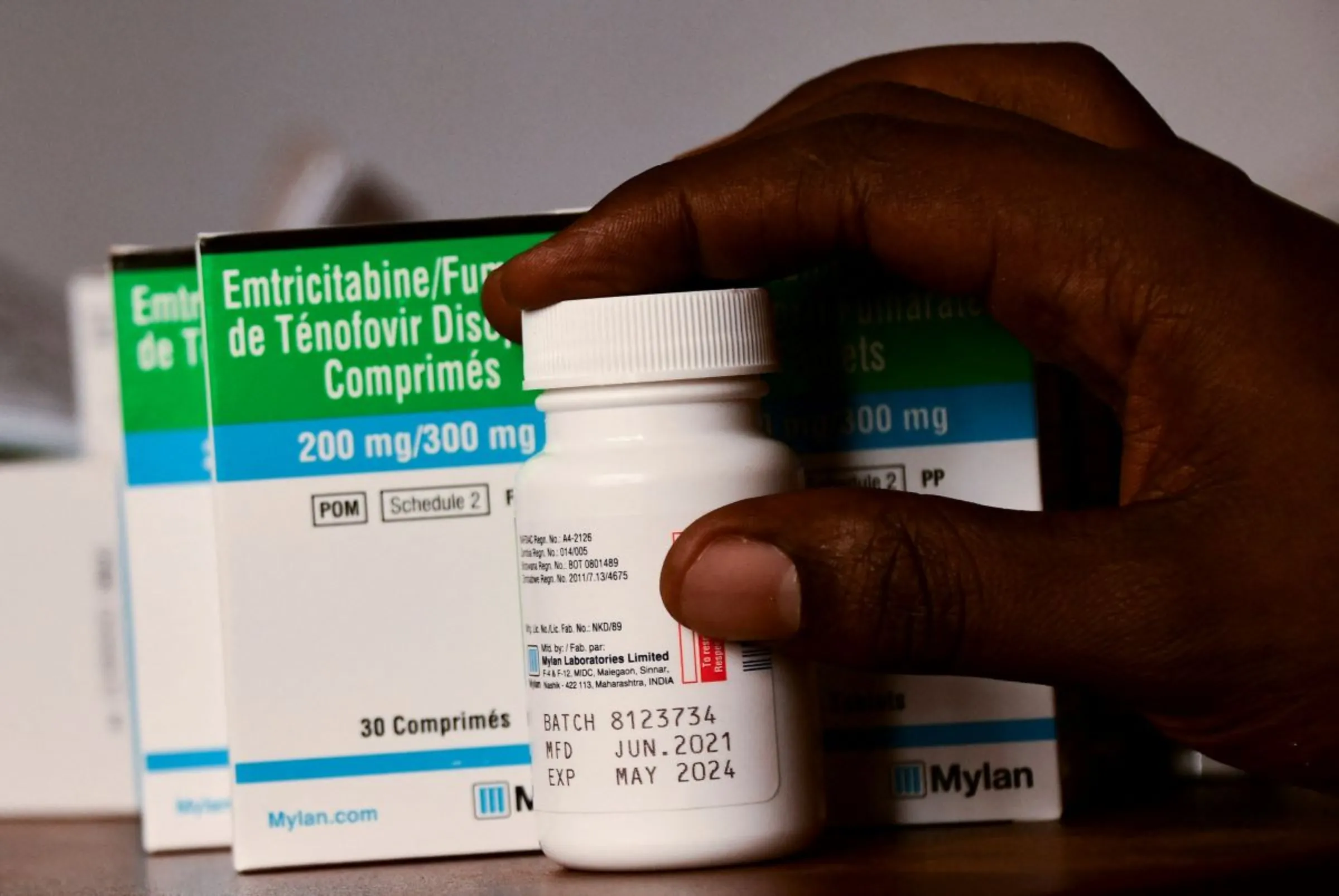 A medical clinic officer holds a package of medicine at his working station that supports HIV/AIDS programmes in Kampala, Uganda June 1, 2023. REUTERS/Abubaker Lubowa