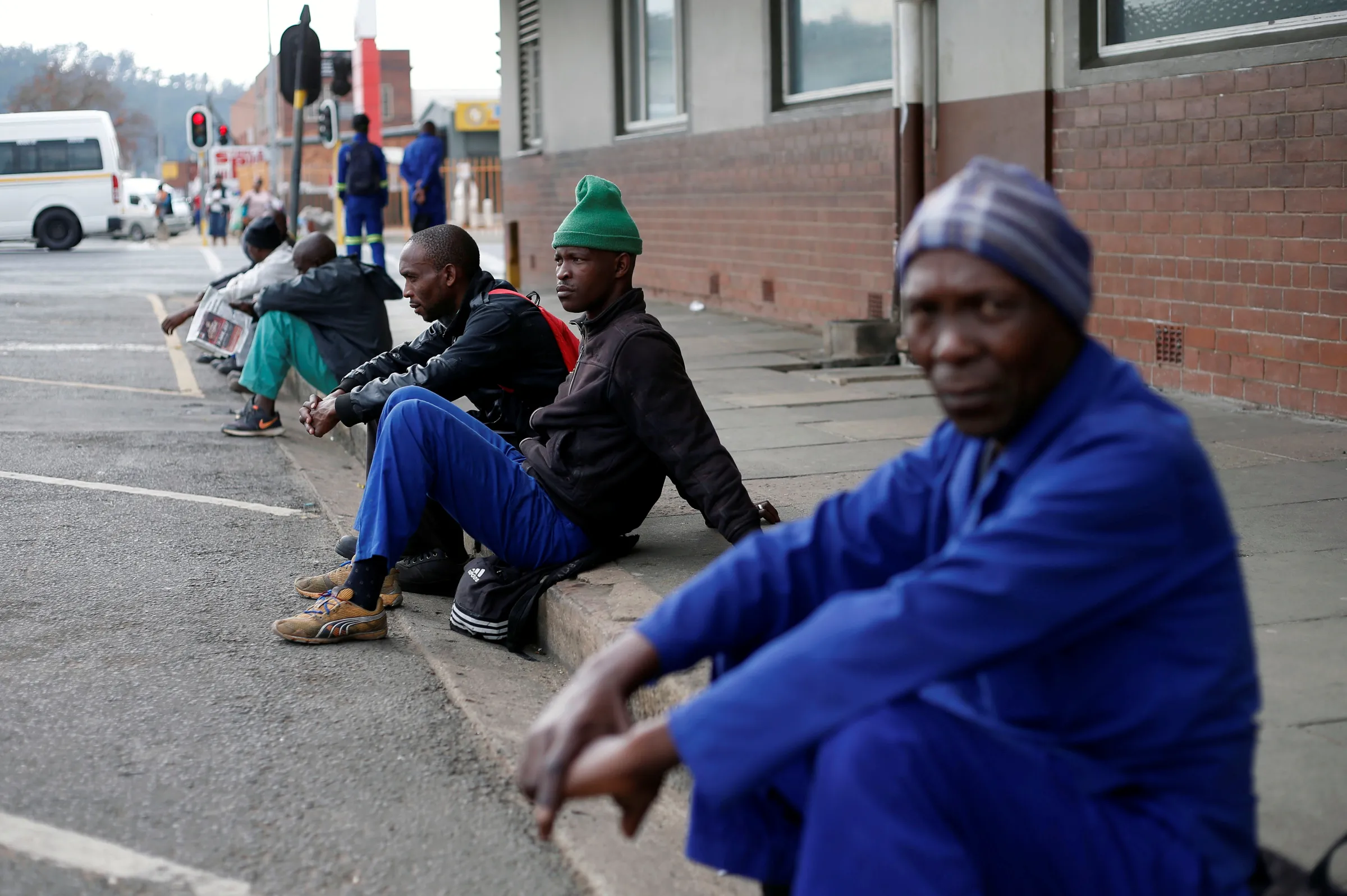 Unemployed men wait on a street corner in the hope of getting casual work in Pietermaritzburg, South Africa June 28, 2017. REUTERS/Rogan Ward