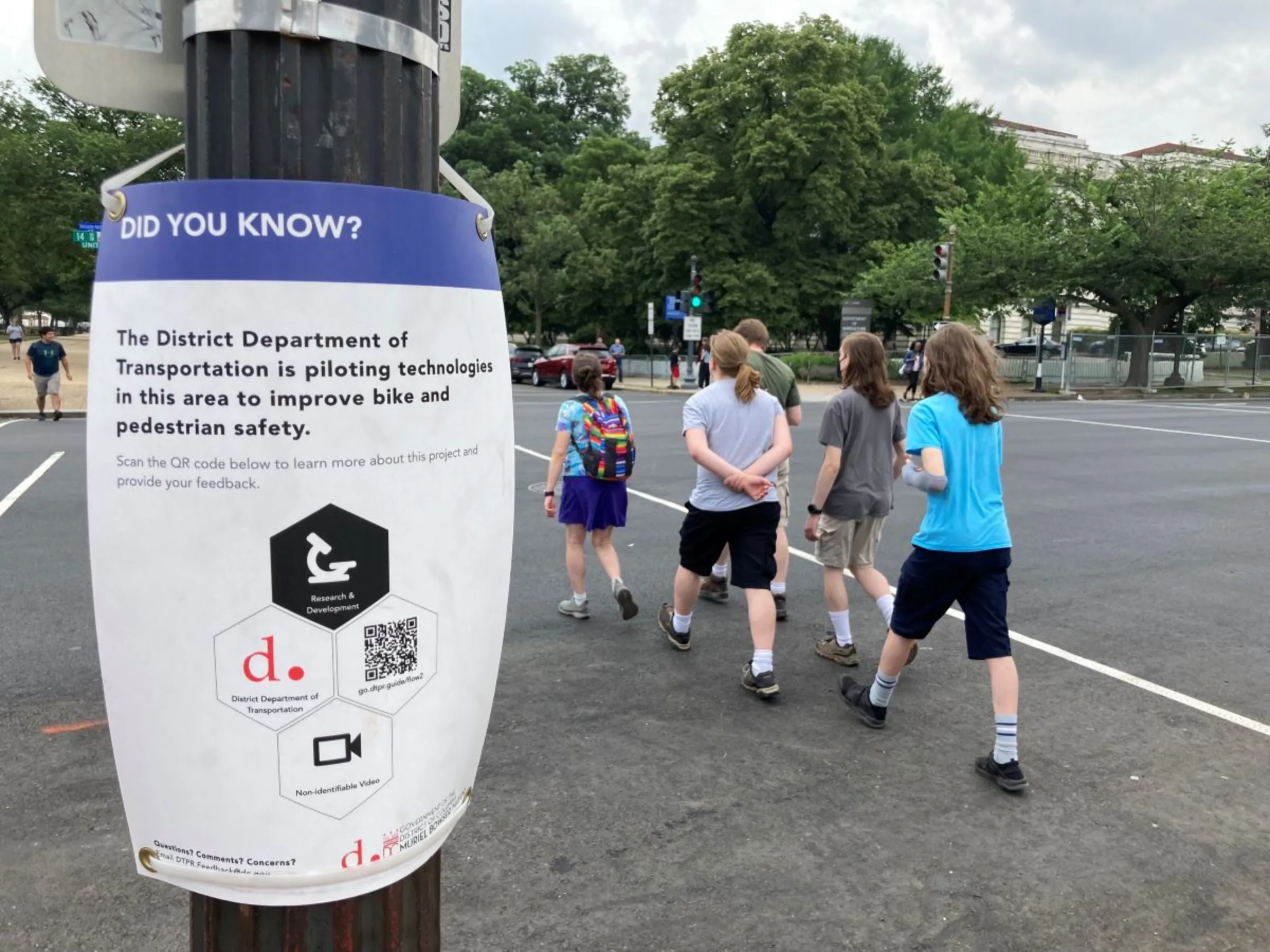 A sign in Washington alerts pedestrians to nearby data-gathering technology in June 2023. Thomson Reuters Foundation/Carey L. Biron