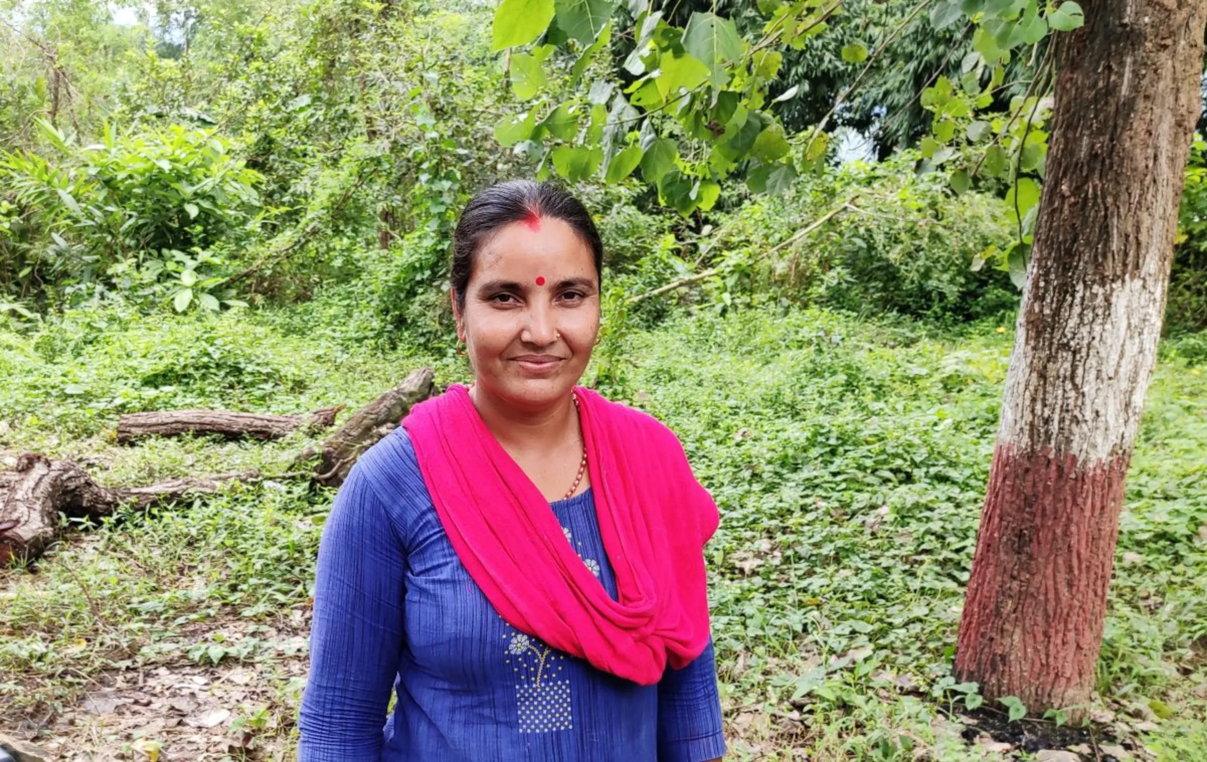 Manakumari Khatri poses for a photo in the Chisapani community forest in Nawalparasi, Nepal. September 29, 2020