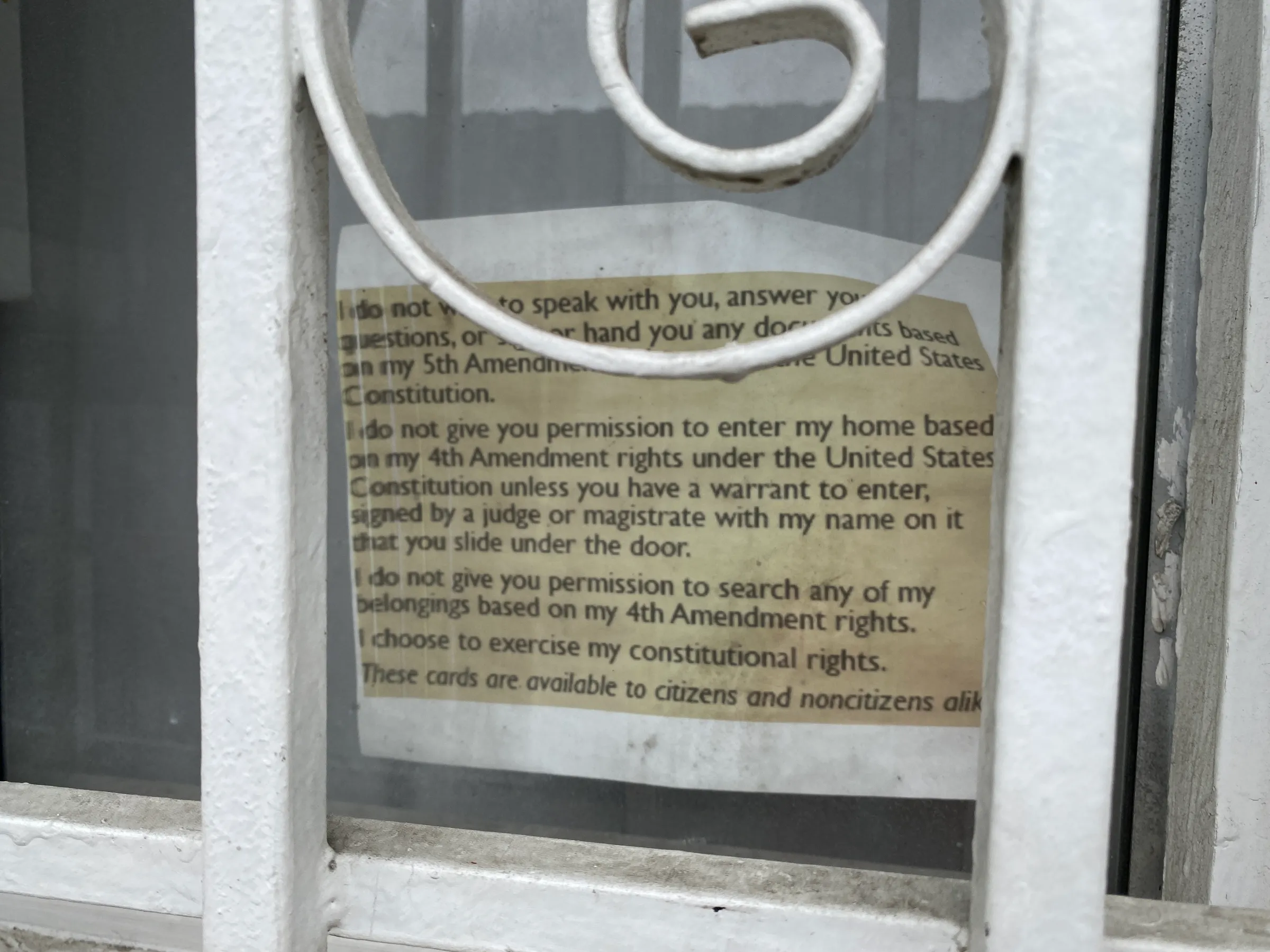 An enlarged copy of a card outlining the civil rights that targets of ICE are entitled to is fixed in a front window. Los Angeles, U.S., July 22, 2025. Thomson Reuters Foundation/Rachel Parsons