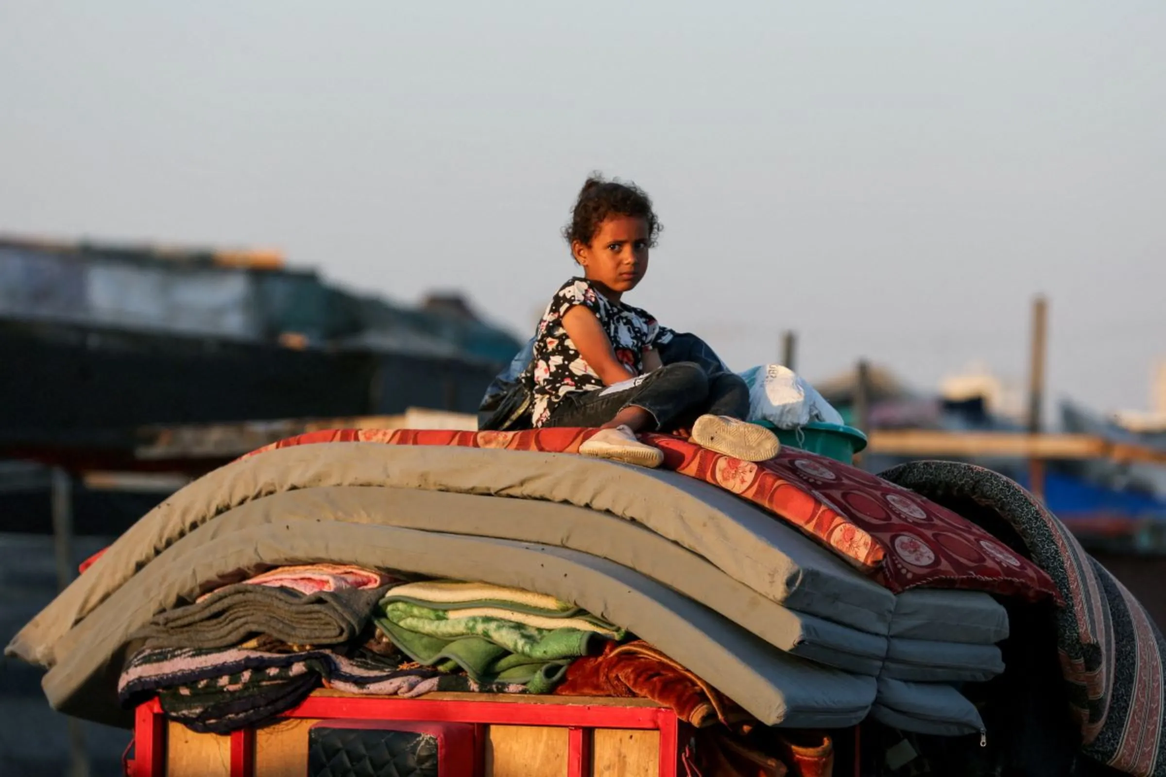 A Palestinian sits on top of belongings as he flees Rafah due to an Israeli military operation, amid the Israel-Hamas conflict, in Rafah, in the southern Gaza Strip, June 7, 2024. REUTERS/Hatem Khaled