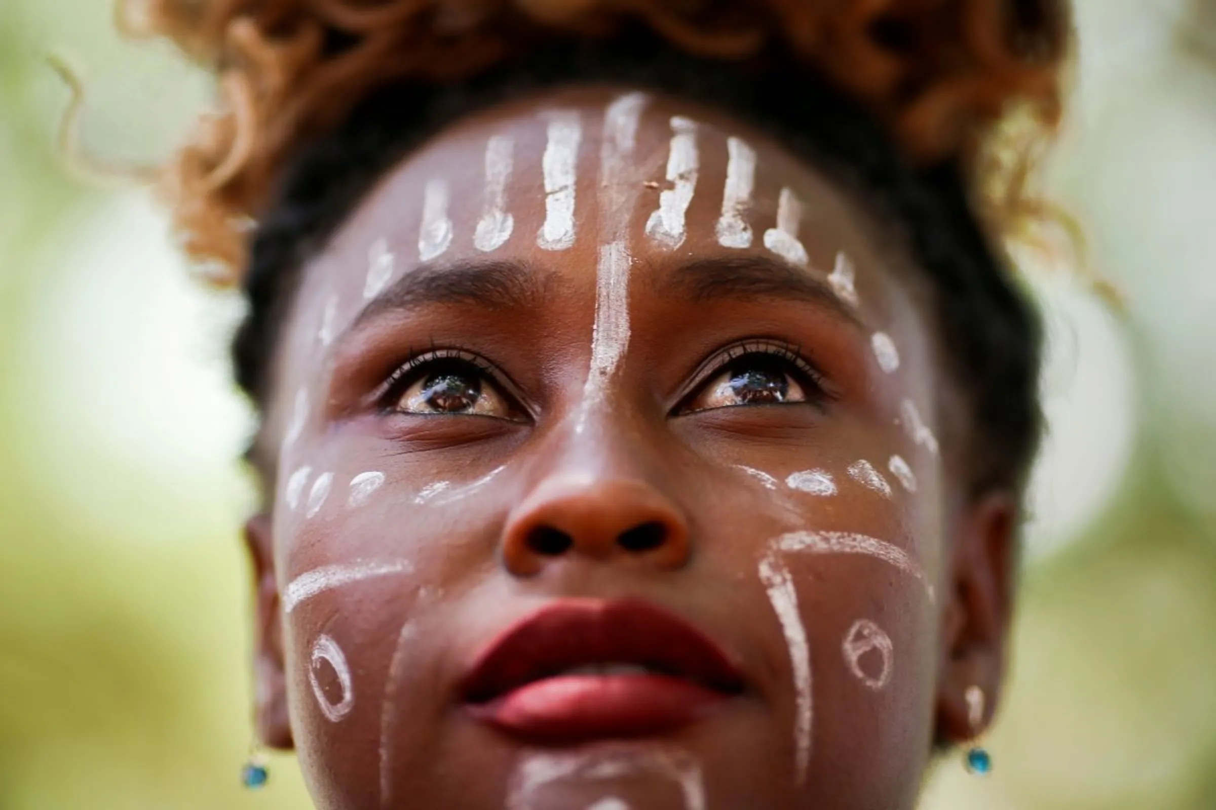 A slave descendant person, or a Quilombola looks on during a protest for recognition and support of Indigenous people in education and against Brazilian President Jair Bolsonaro's Government in Brasilia, Brazil October 7, 2021