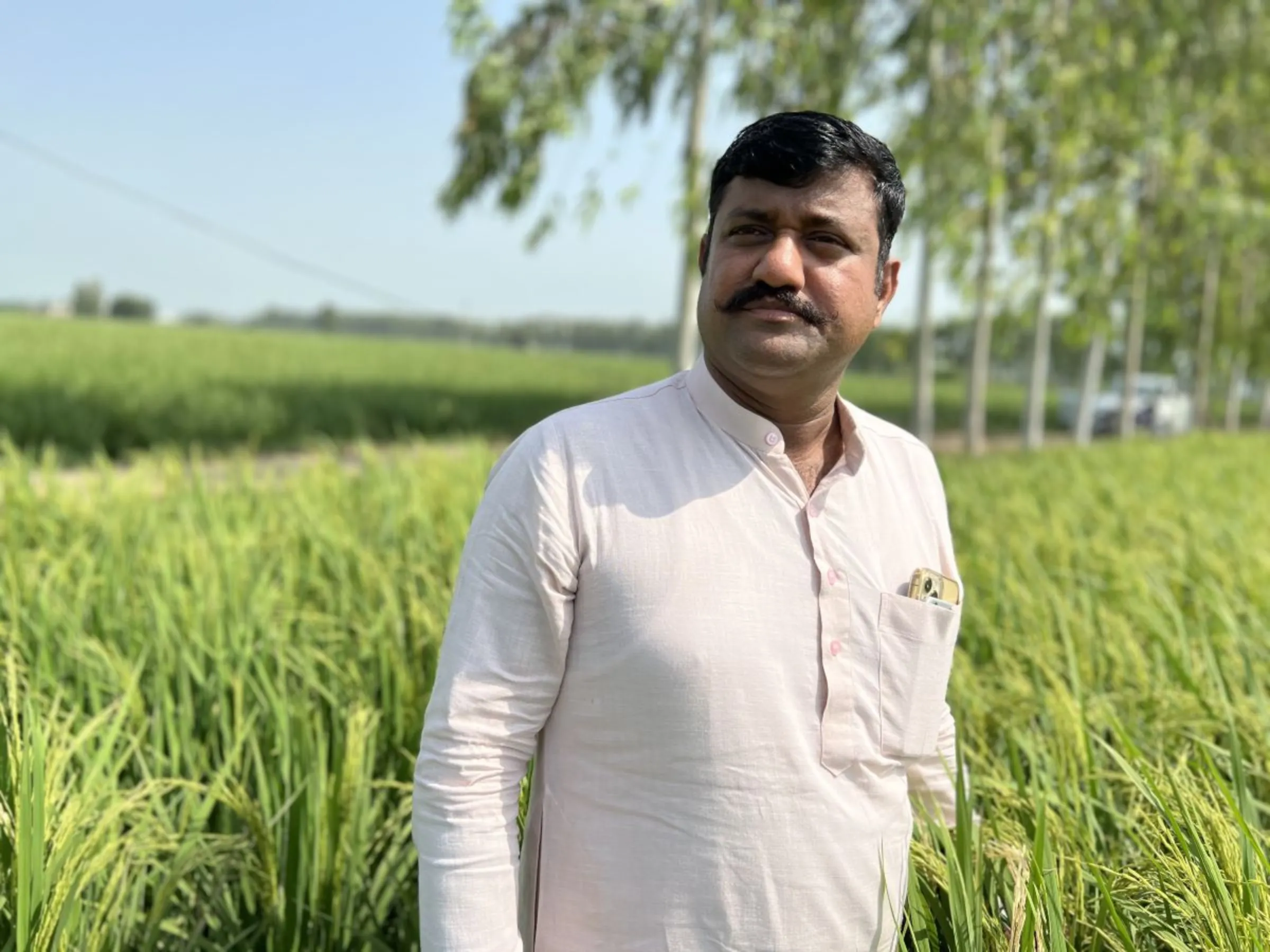 Farmer Jitendra Singh poses in a field where he is growing rice using eco-friendly practices, slashing methane emissions and generating carbon credits, in Karnal district, Haryana state, India, September 1, 2023. Thomson Reuters Foundation/Bhasker Tripathi