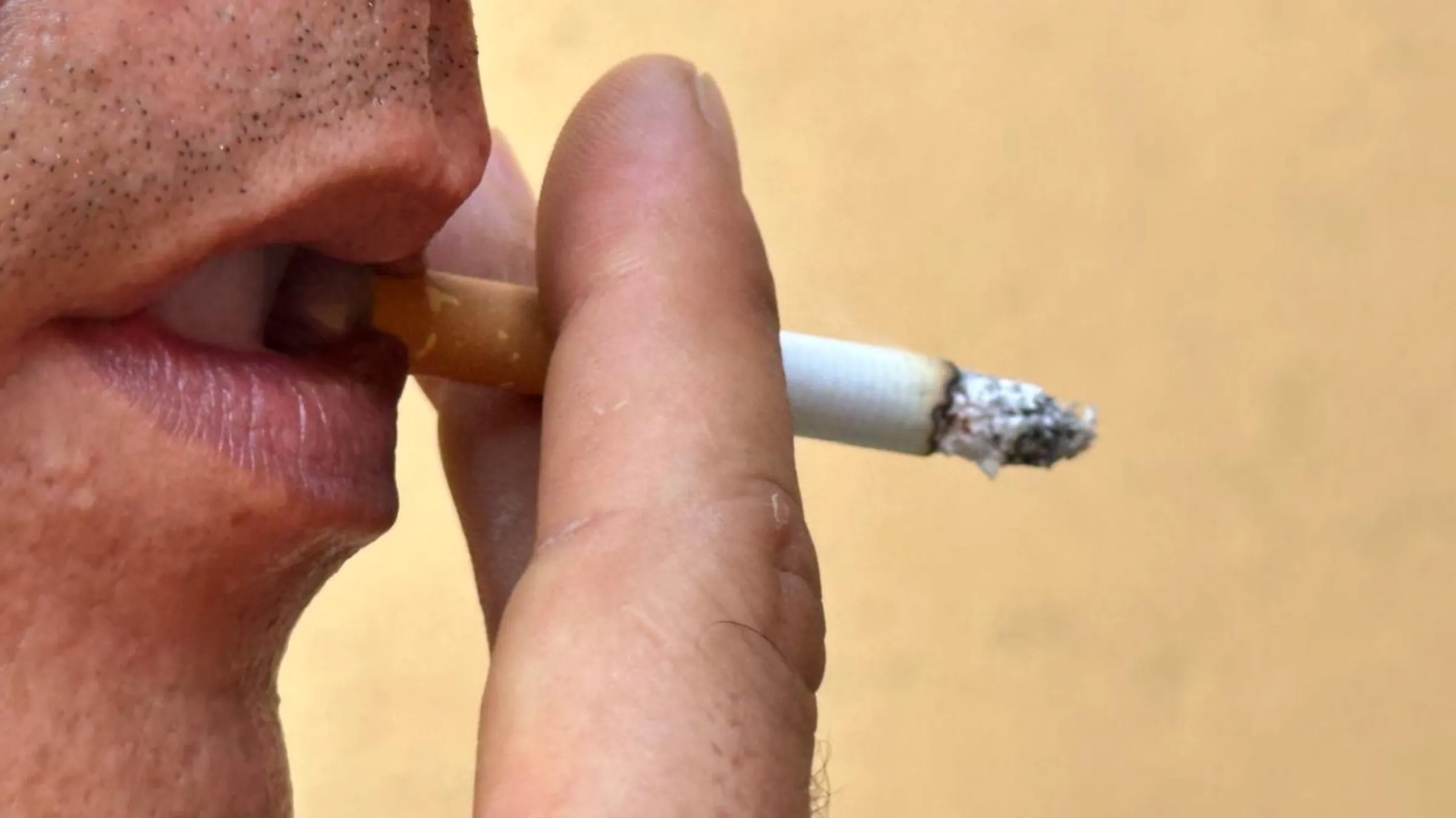 A smuggler working in the Mexico-Guatemala border smokes during an interview in Mexico, December 9, 2024. Thomson Reuters Foundation