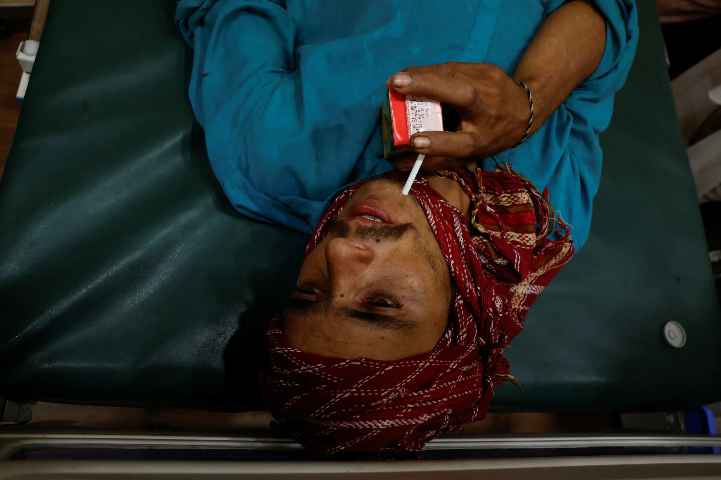 A labourer drinks juice at the Heat Stroke Response Centre in Civil Hospital in Jacobabad, Pakistan May 25, 2024. REUTERS/Akhtar Soomro