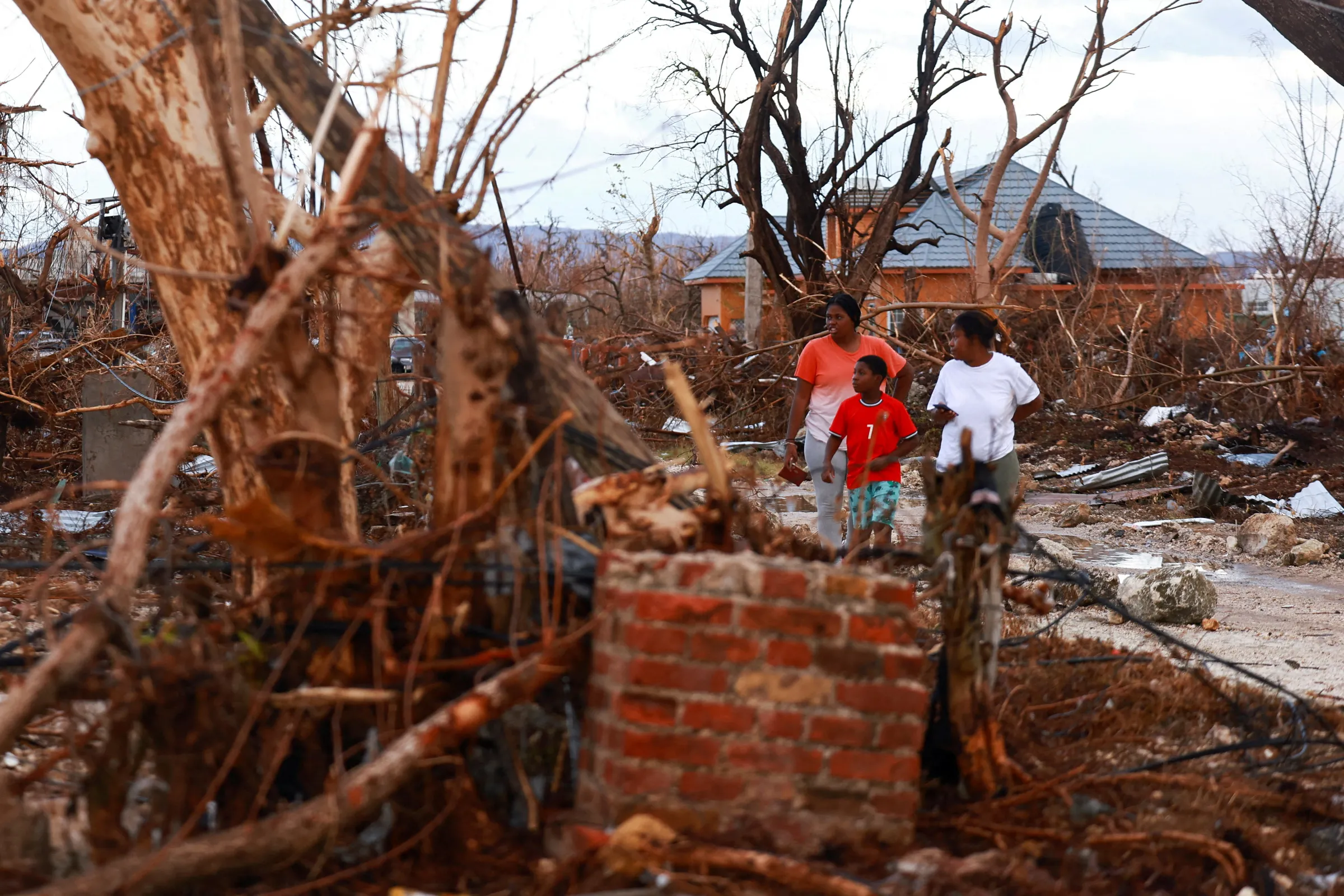People inspect the damage in the aftermath of Hurricane Melissa, in Black River, Jamaica, November 5, 2025. REUTERS/Raquel Cunha