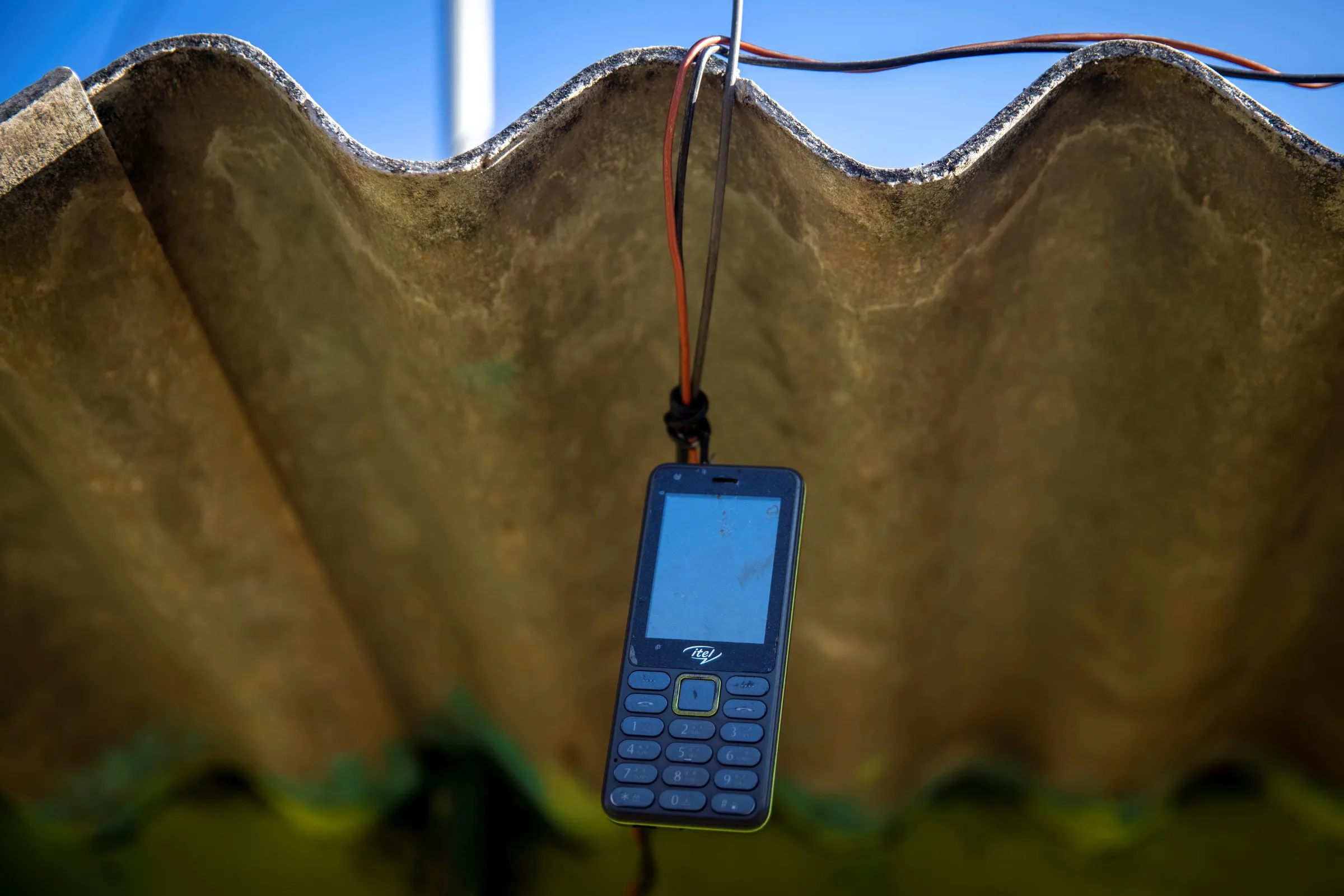 A phone is hung up outside to receive signal, in Pendajam village in Koraput, India, January 16, 2021. REUTERS/Danish Siddiqui
