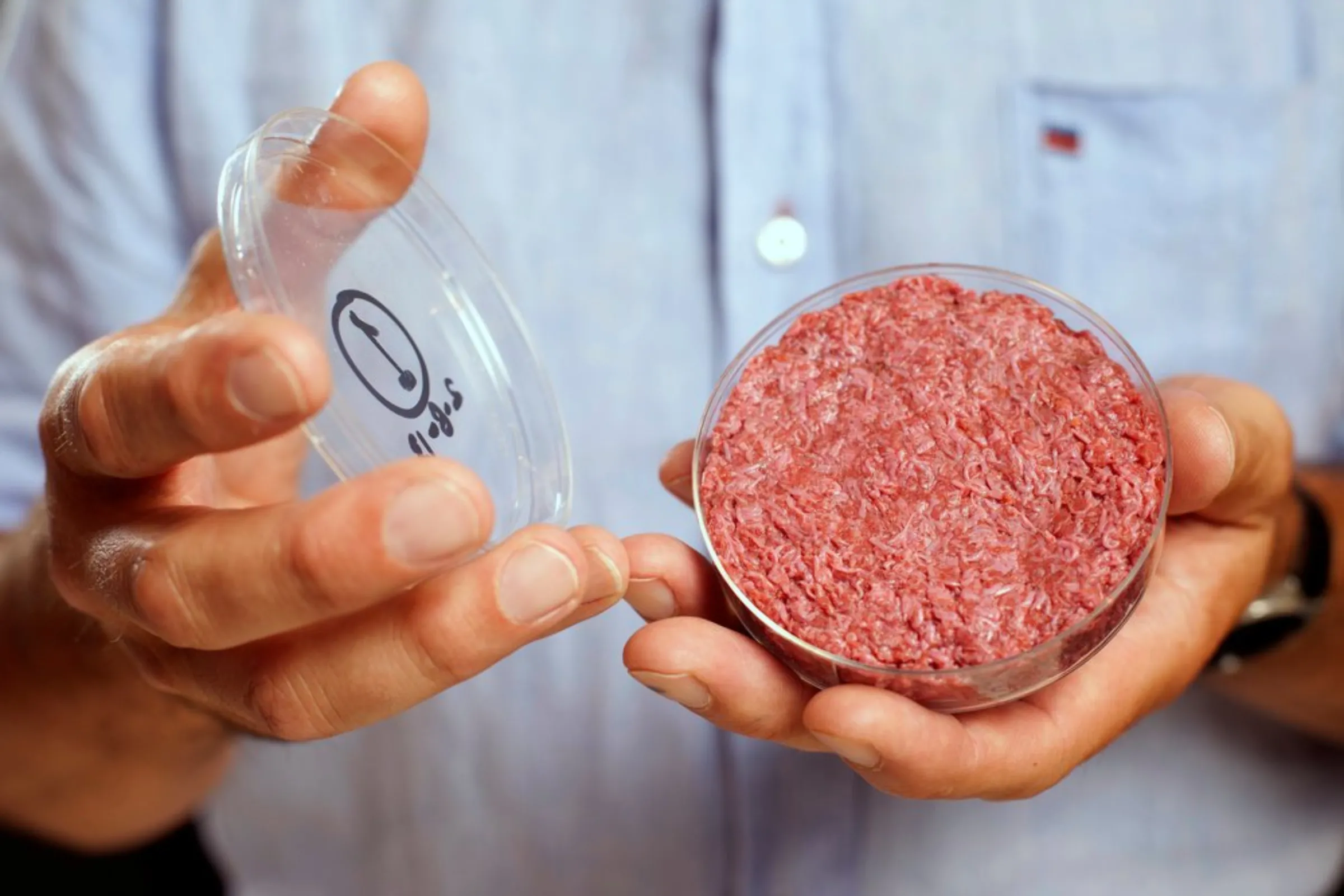 Professor Mark Post holds the world's first lab-grown beef burger during a launch event in west London August 5, 2013