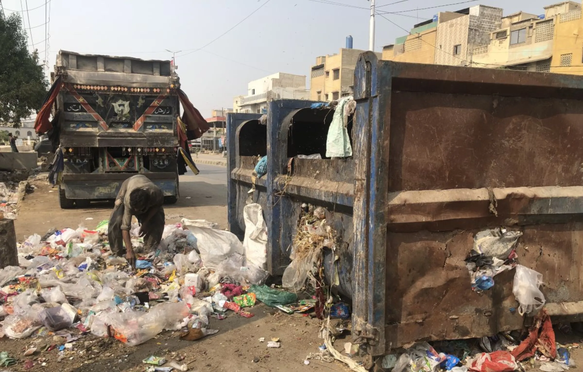 A waste picker scours the government waste dump near Shireen Jinnah Colony in Karachi, Pakistan, November 9, 2023