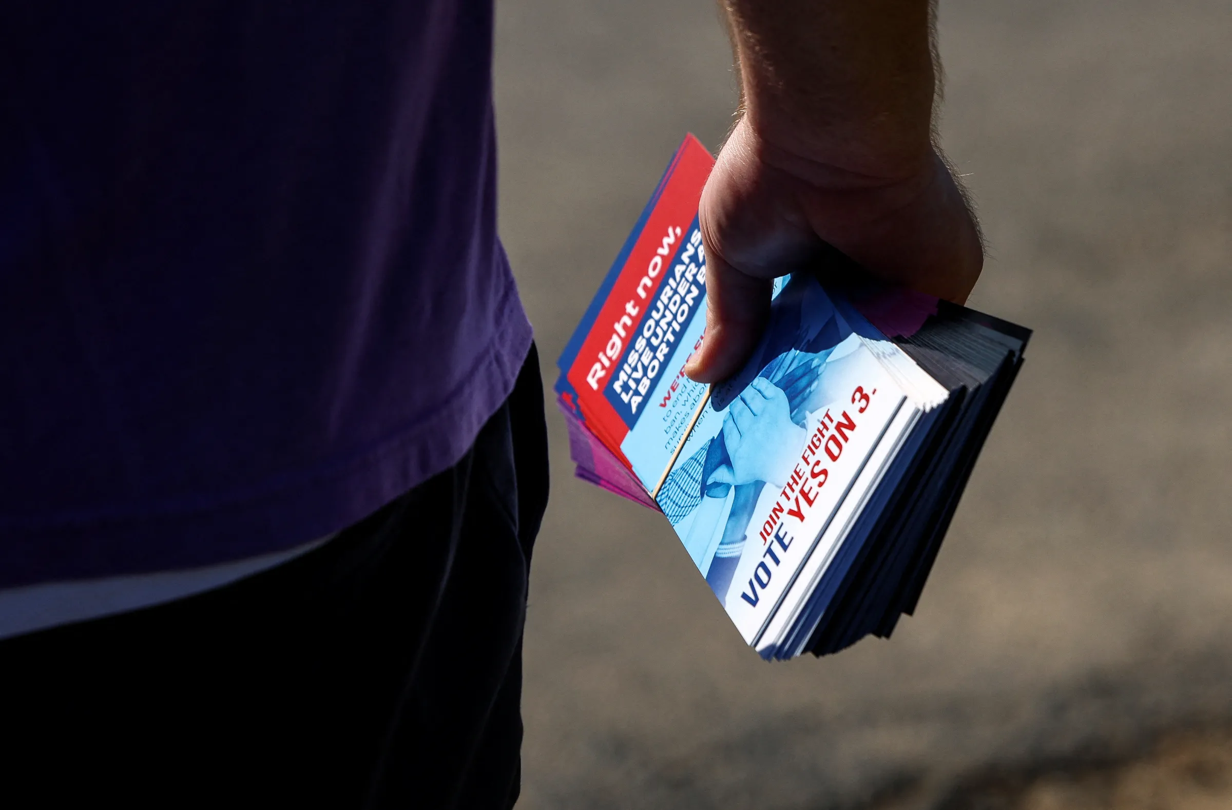 A canvasser holds leaflets for Amendment 3, a measure that would establish a constitutional right to abortion, in Claycomo, Missouri, U.S., October 12, 2024. REUTERS/Evelyn Hockstein