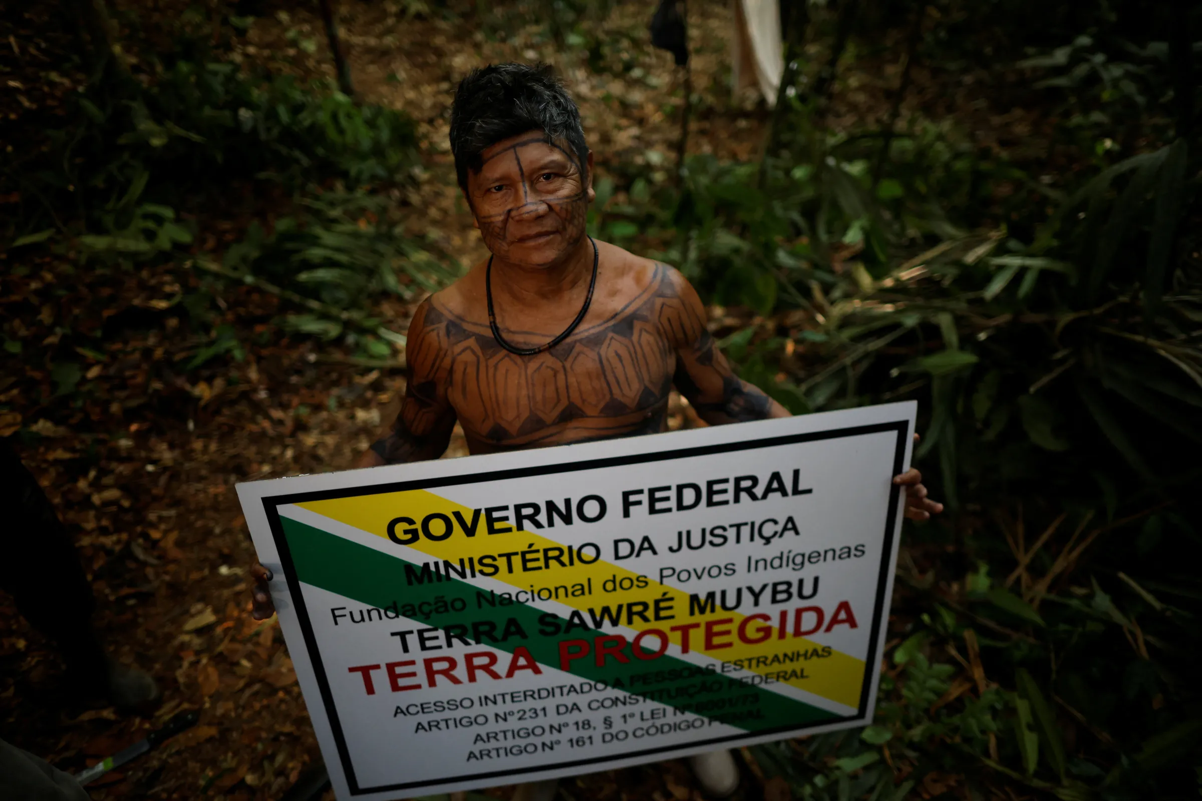 Chief of the Sawre Muybu village poses for a picture holding a demarcation sign to mark the frontier of the Sawre Muybu Indigenous Territory, in Itaituba municipality, Para state, Brazil, July 19, 2024. REUTERS/Adriano Machado