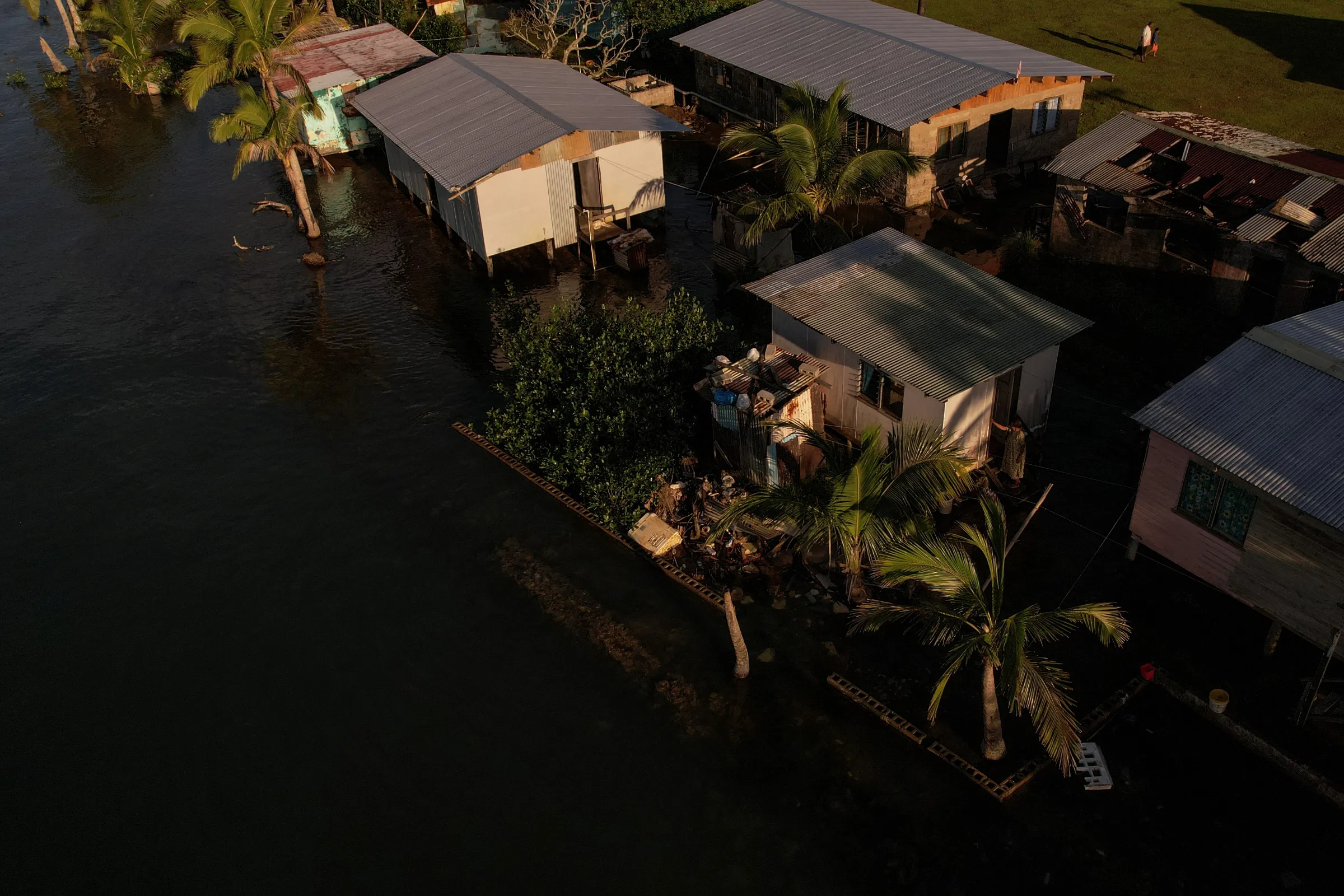Seawater floods past an ineffective sea wall into the community of Veivatuloa Village, Fiji, July 16, 2022. REUTERS/Loren Elliott
