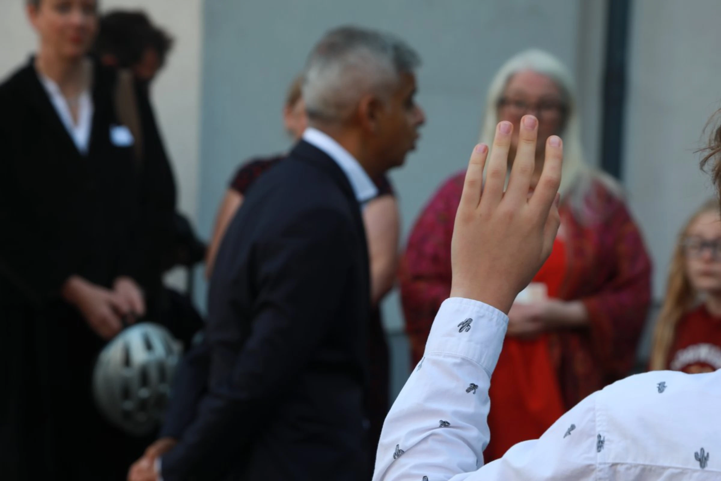 A school student raises their hand to ask a question of London Mayor Sadiq Khan at Prior Weston Primary School in central London, England, on September 23, 2021