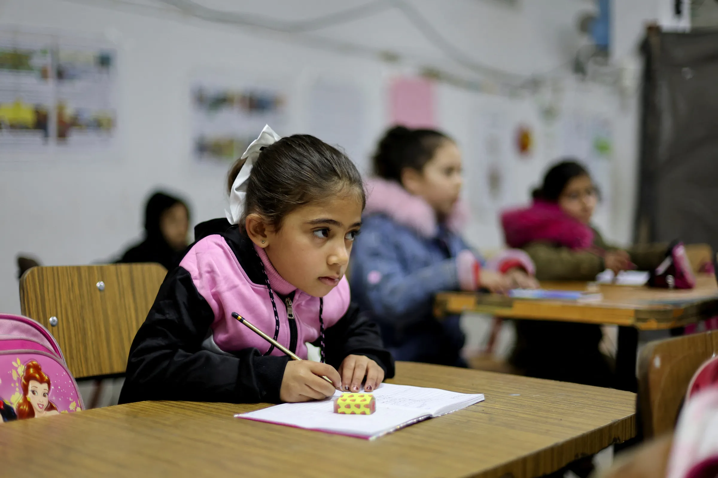 A Palestinian child attends a lesson in a classroom at a damaged school, amid a ceasefire between Israel and Hamas, in Gaza City, February 25, 2025. REUTERS/Dawoud Abu Alkas