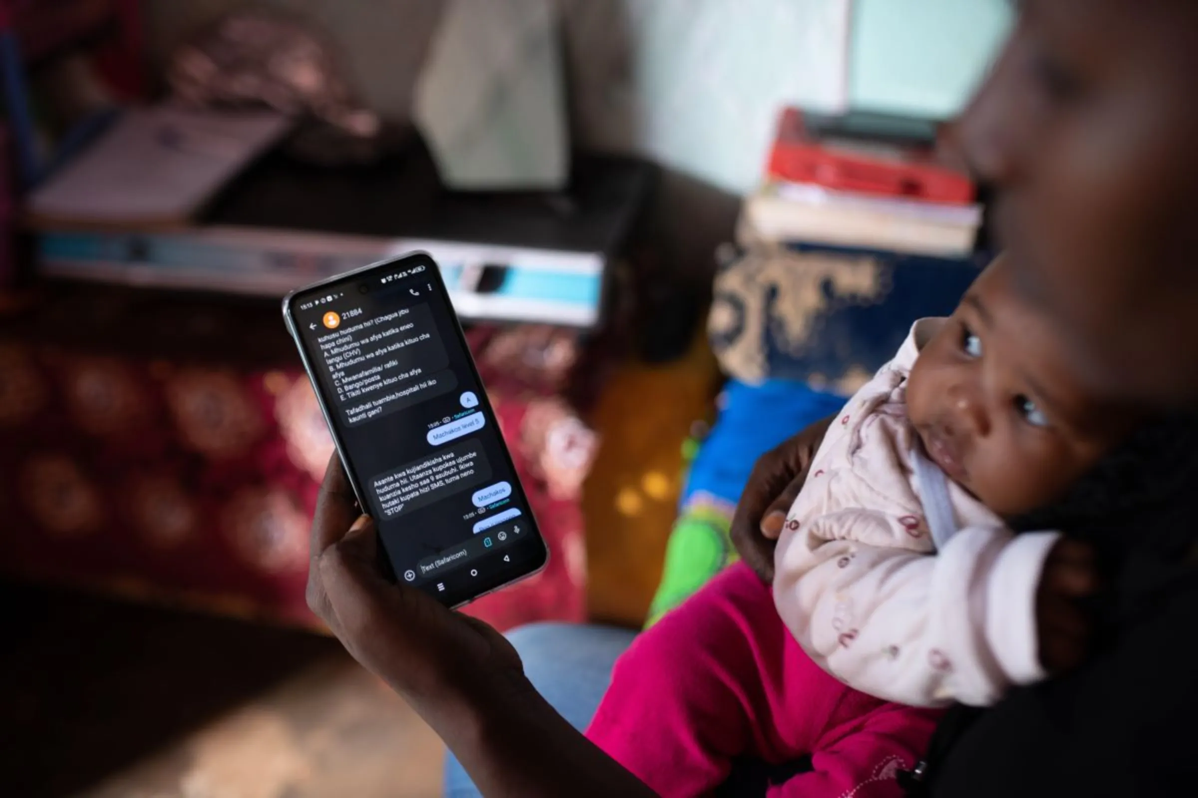 A Kenyan mother uses a maternal health SMS service developed by Jacaranda Health, which has pioneered the first LLM operating in Swahili in East Africa. Jacaranda Health/Handout via Thomson Reuters Foundation
