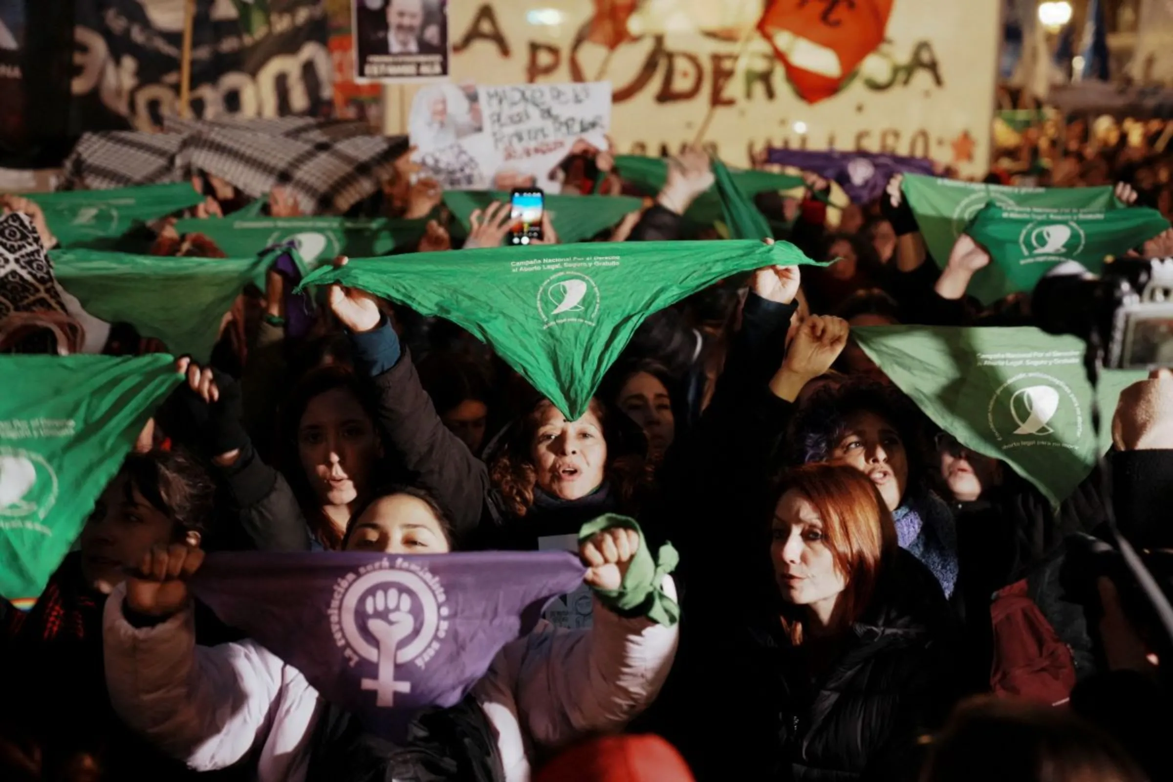 Women hold green handkerchiefs, symbolizing the abortion rights movement, to protest against violence towards women outside the National Congress, in Buenos Aires, Argentina June 3, 2024. REUTERS/Irina Dambrauskas