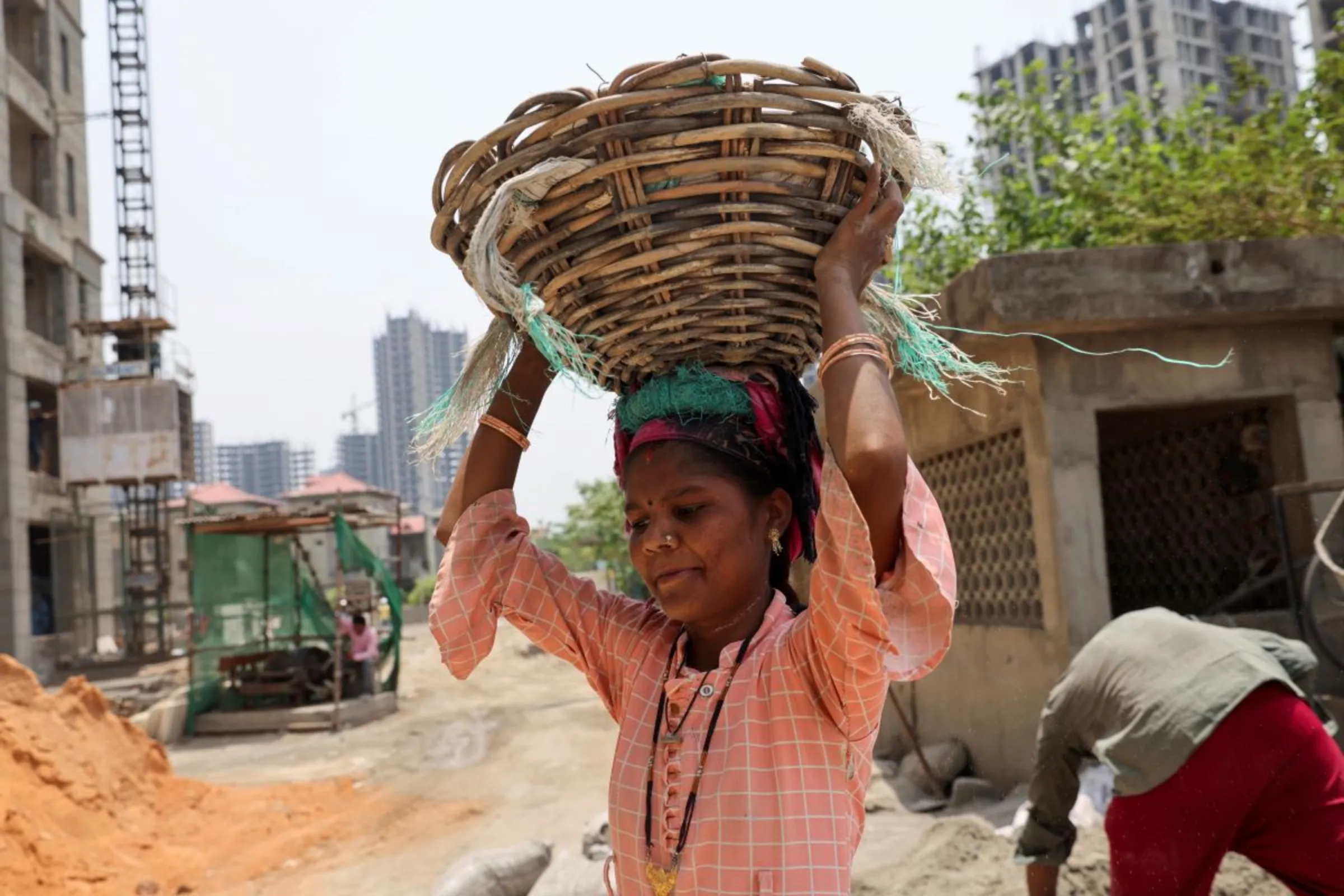 A labourer works at a construction site on a hot summer day in Noida, India, May 12, 2022. REUTERS/Anushree Fadnavis