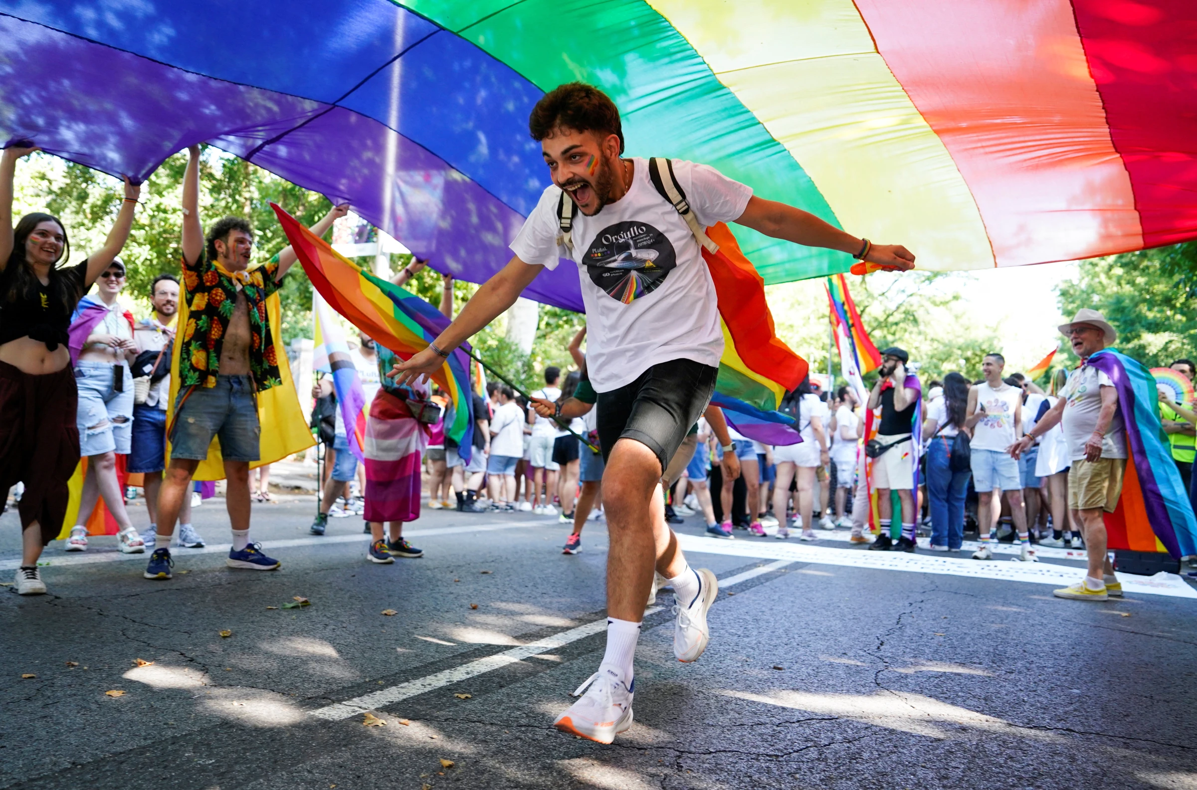 A person reacts under a rainbow flag, as people take part in the annual LGBT Pride Parade in Madrid, Spain July 6, 2024. REUTERS/Ana Beltran
