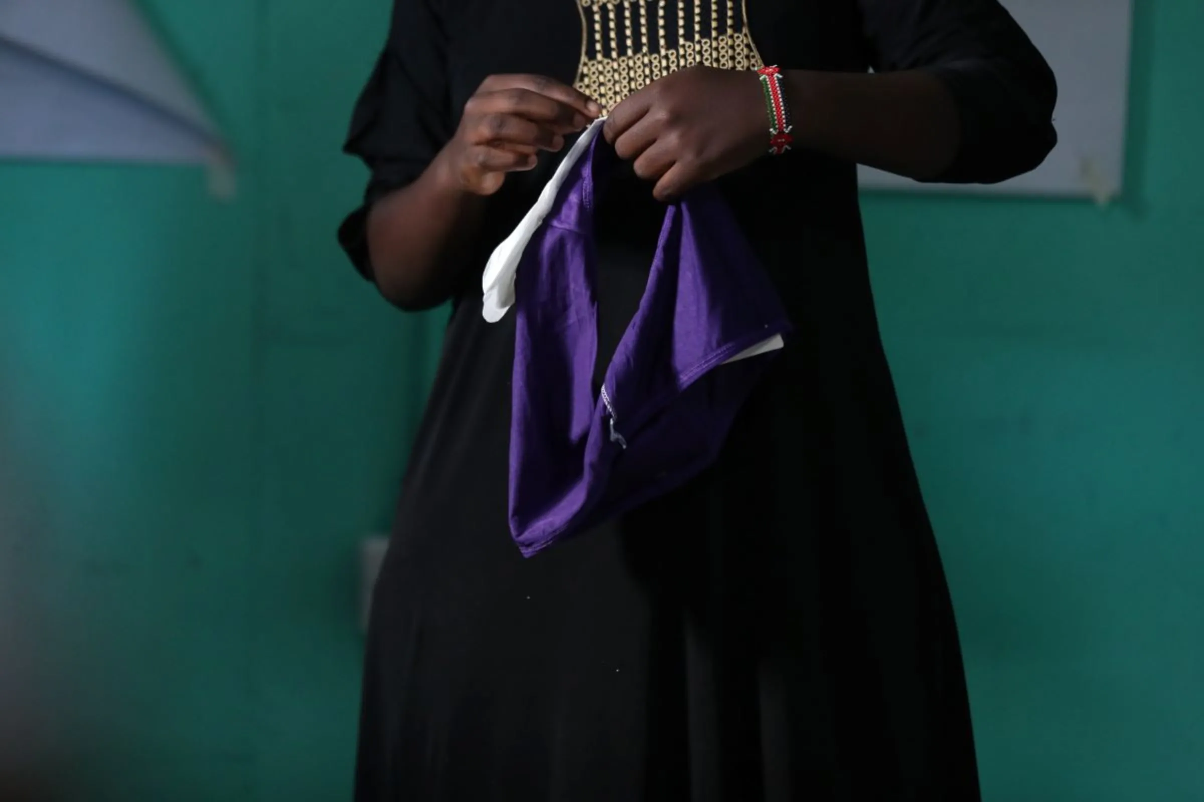 Yasmin Nassur, founder of community-based organisation SUPERB, shows young women and girls how to use sanitary pads in Kibera informal settlement in Nairobi, Kenya on April 15, 2023