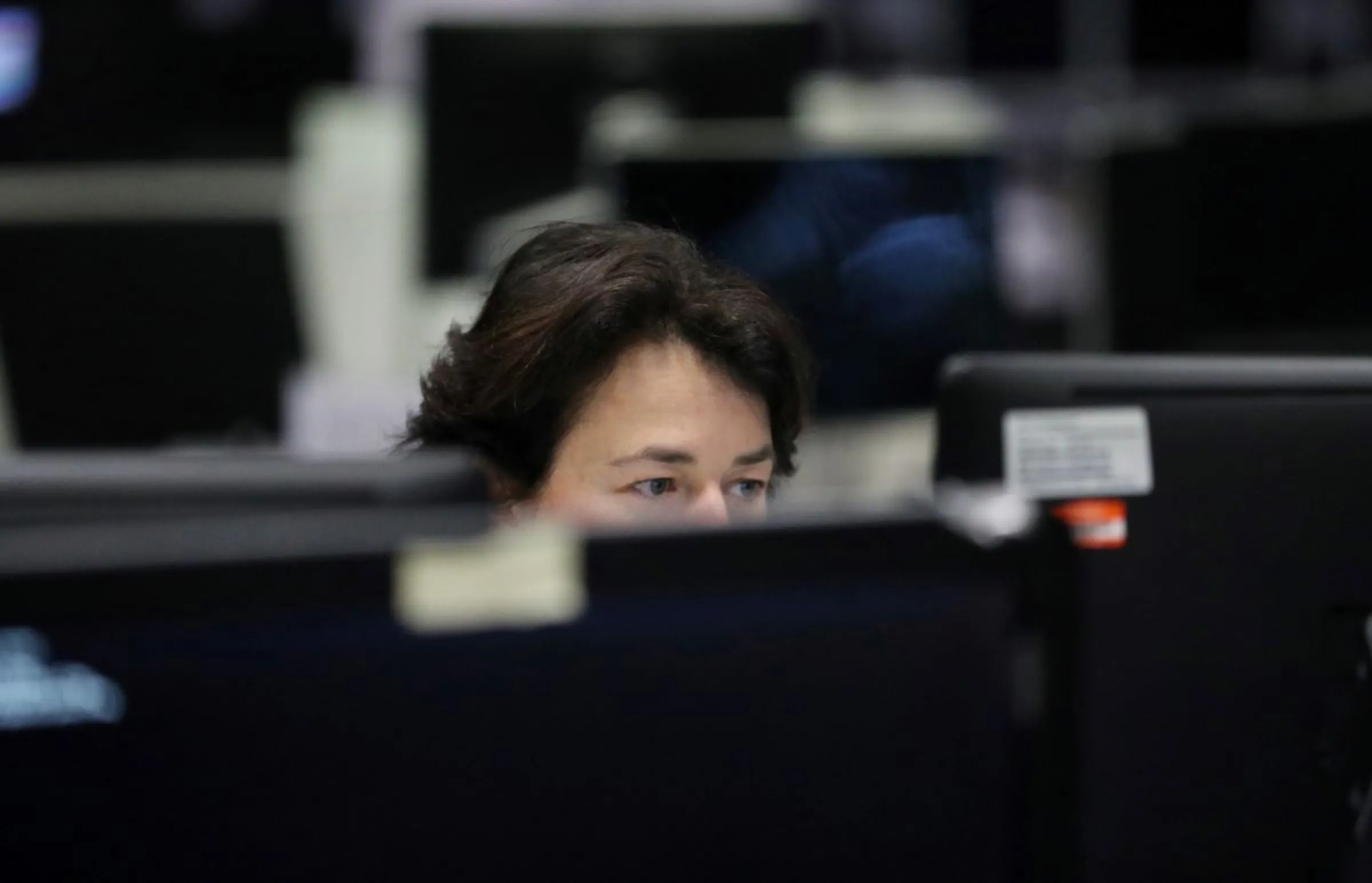 A woman works at a desk in the Lloyd's of London building in the City of London financial district in London, Britain, April 16, 2019.REUTERS/Hannah McKay