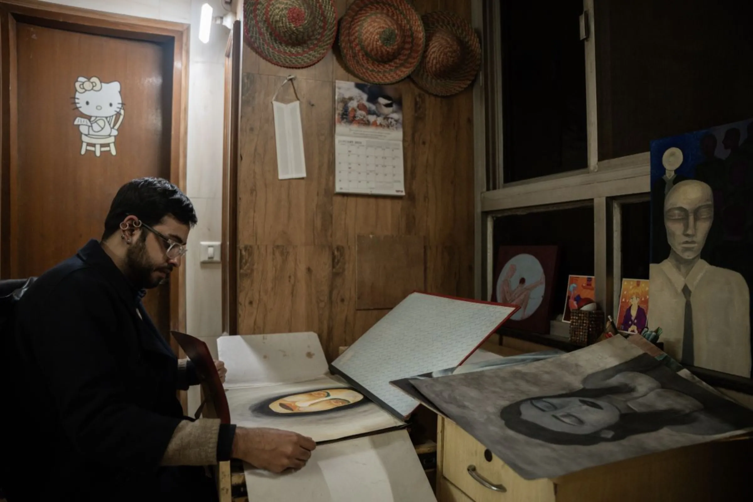 Reyansh Naarang, a non-binary lawyer, looks at one of his paintings at his residence in New Delhi, India, December 17, 2023. Thomson Reuters Foundation/Mehran Firdous