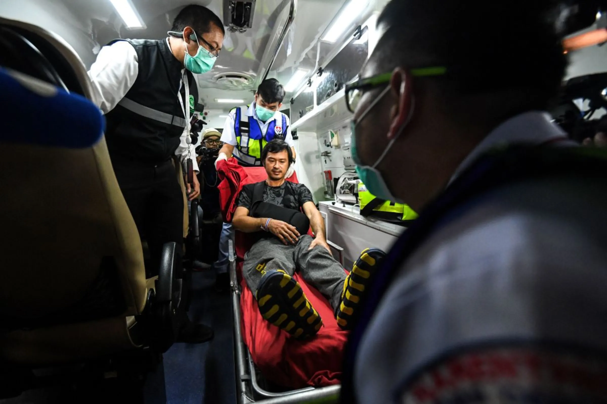 A migrant agricultural worker who was injured by a surprise attack on Israel by the Palestinian militant group Hamas, is helped by medical workers, as he arrives after being repatriated from Israel at Bangkok's Suvarnabhumi Airport, Thailand, October 12, 2023. REUTERS/Chalinee Thirasupa