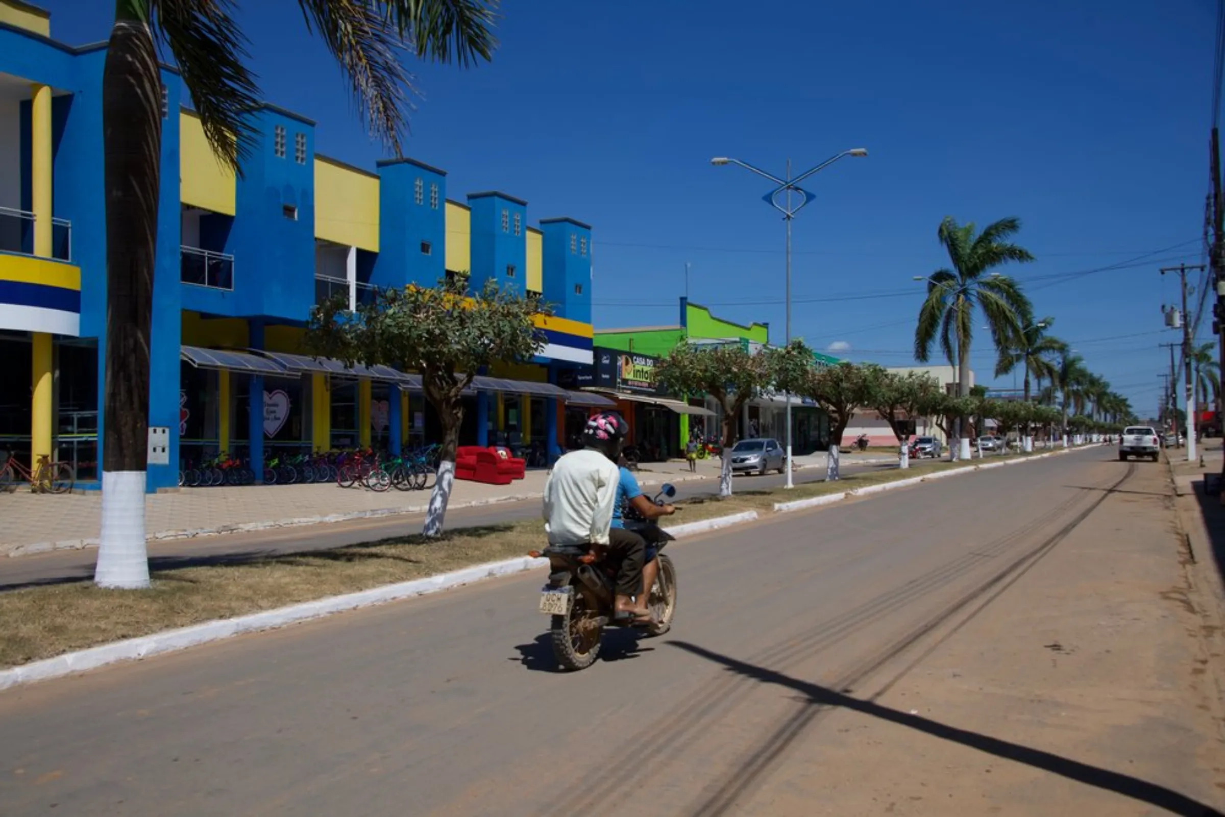 A motorcycle drives down the main street in Colniza, in the state of Mato Grosso, Brazil, May 31, 2022
