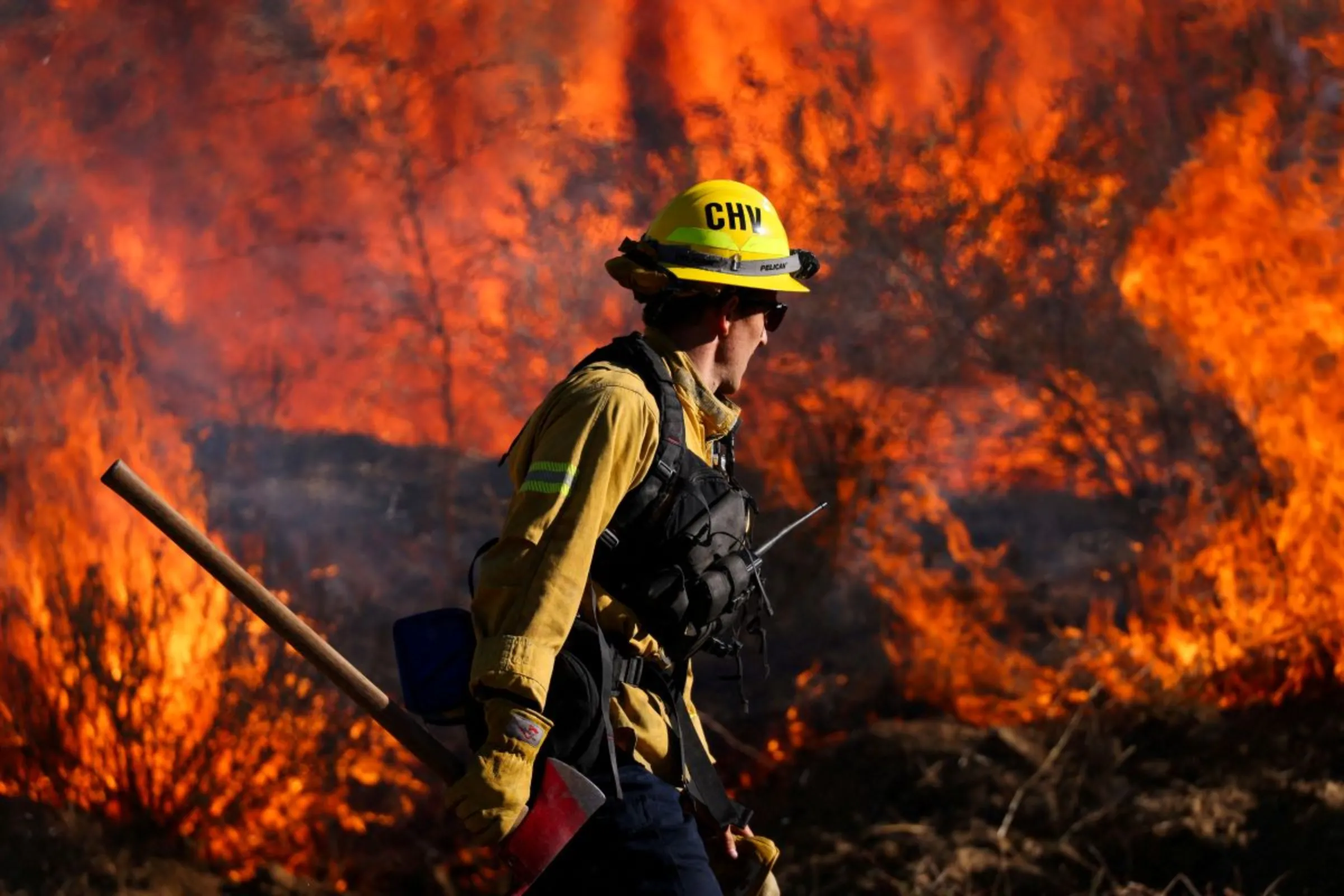 A firefighter works to extinguish the Highland Fire, a wind driven wildfire near Aguanga, California, U.S., October 31, 2023