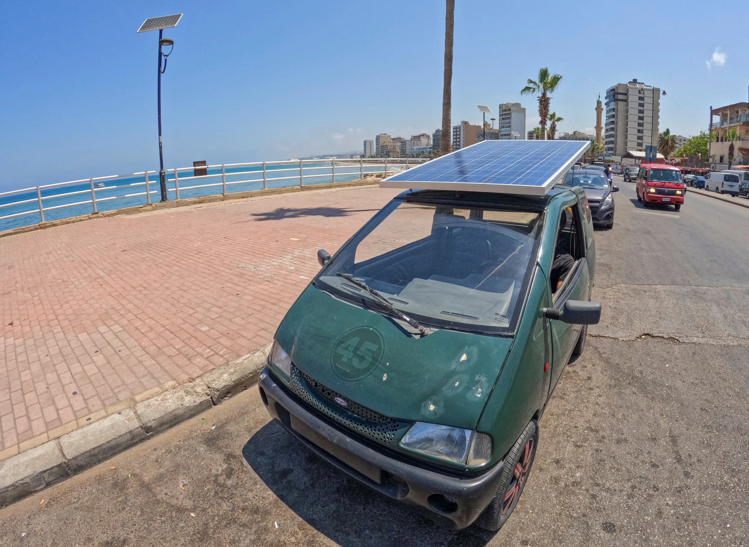 A custom-made electric vehicle parked, powered by a solar panel at the corniche of port-city of Sidon, Lebanon June 23, 2022