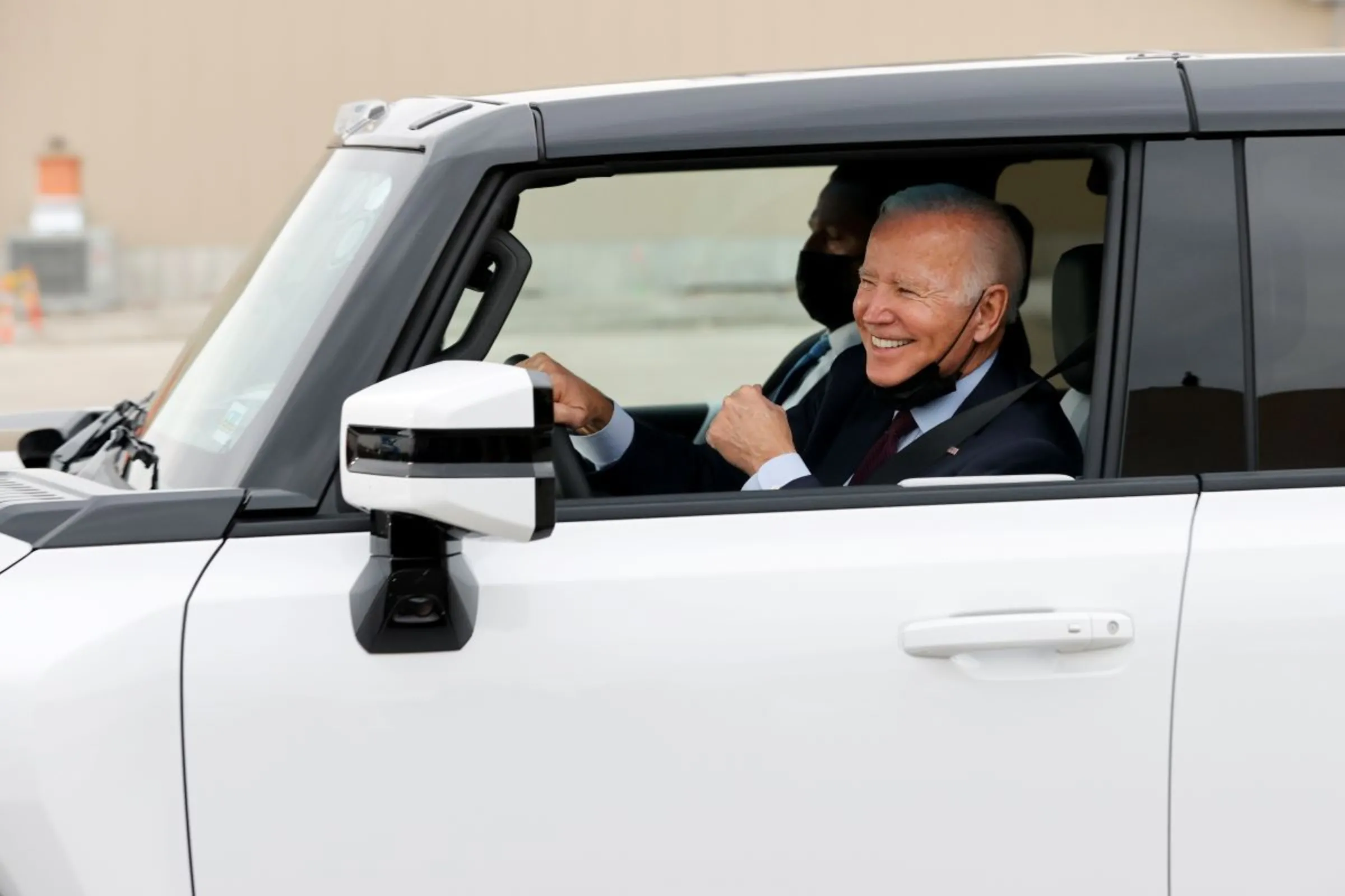 U.S. President Joe Biden gestures after driving a Hummer EV during a tour at the General Motors 'Factory ZERO' electric vehicle assembly plant in Detroit, Michigan, U.S. November 17, 2021
