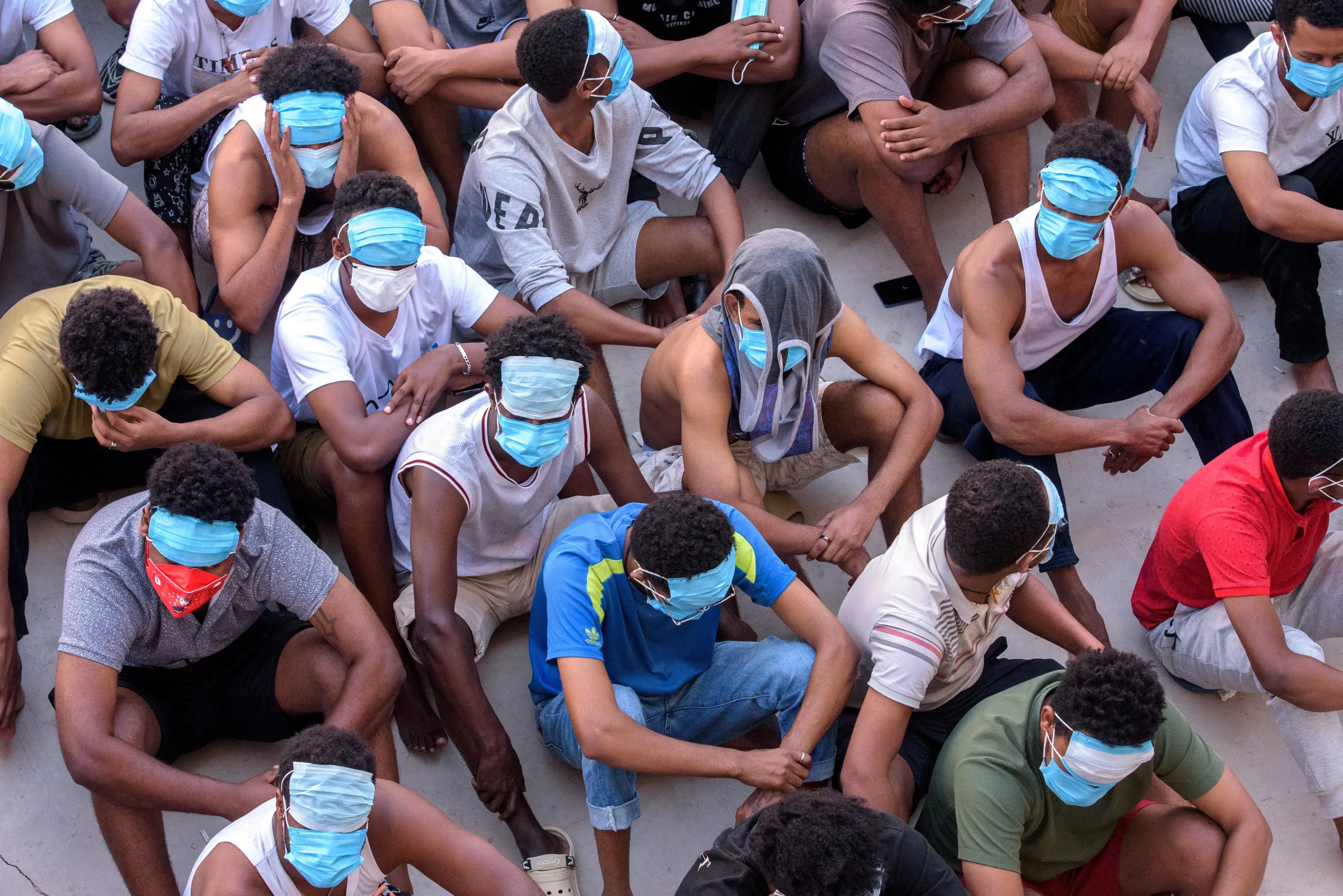 Victims of scam centers wait at a compound inside the KK Park, a fraud factory, and a human trafficking hub on the border with Thailand-Myanmar in Myawaddy, Myanmar, February 26, 2025. REUTERS/Stringer